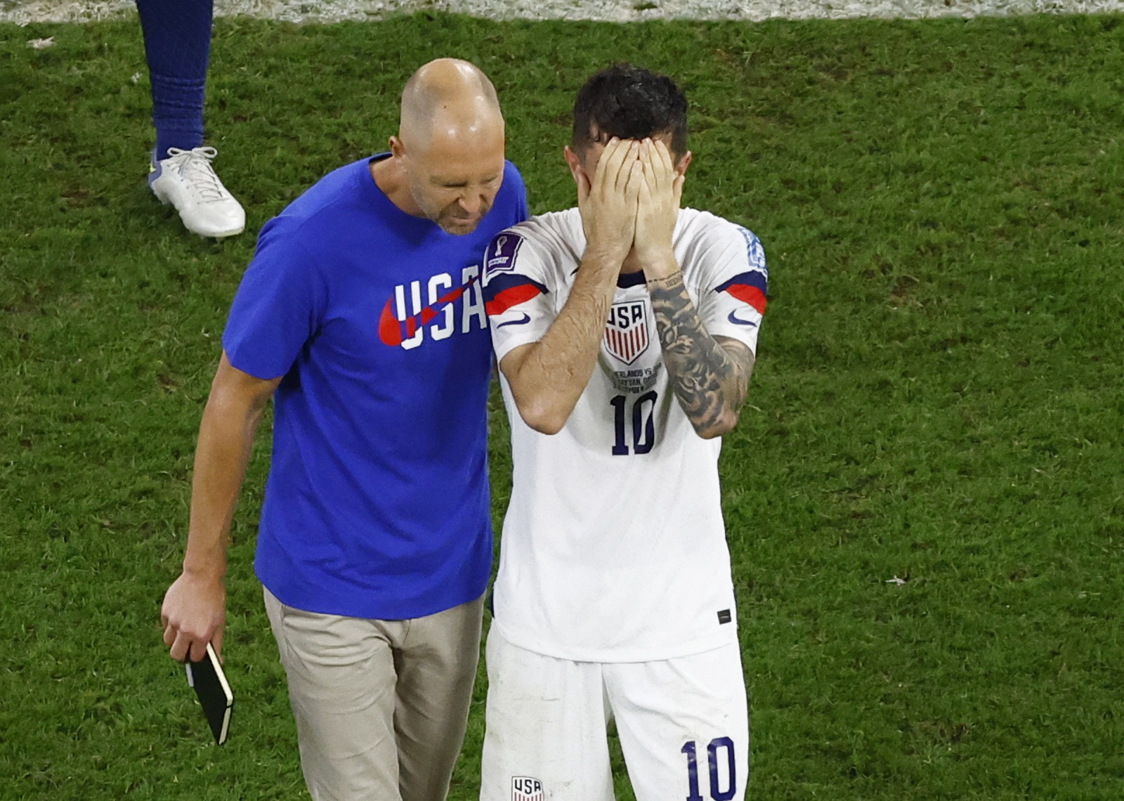 Soccer Football - FIFA World Cup Qatar 2022 - Round of 16 - Netherlands v United States - Khalifa International Stadium, Doha, Qatar - December 3, 2022 U.S. coach Gregg Berhalter and Christian Pulisic look dejected after the match as United States are eliminated from the World Cup REUTERS