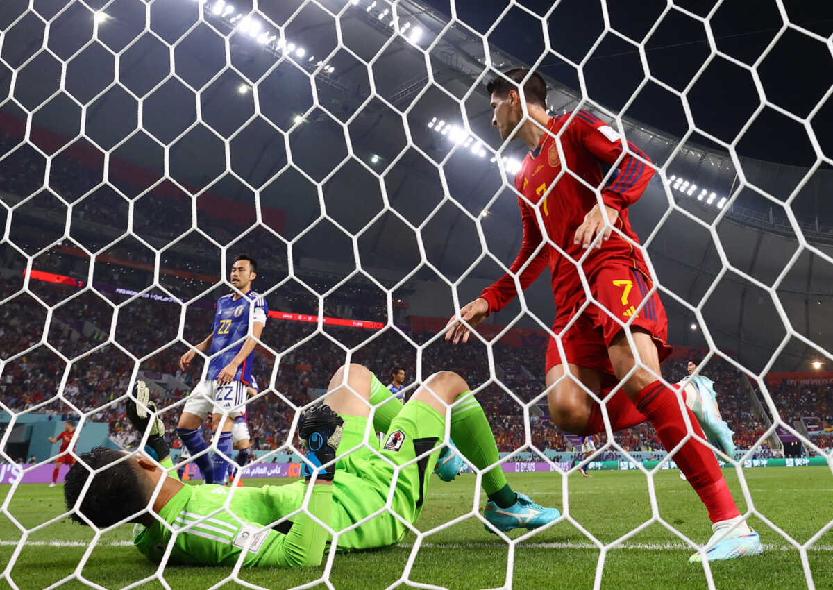 Soccer Football - FIFA World Cup Qatar 2022 - Group E - Japan v Spain - Khalifa International Stadium, Doha, Qatar - December 1, 2022 Spain's Alvaro Morata celebrates scoring their first goal as Japan's Shuichi Gonda reacts REUTERS