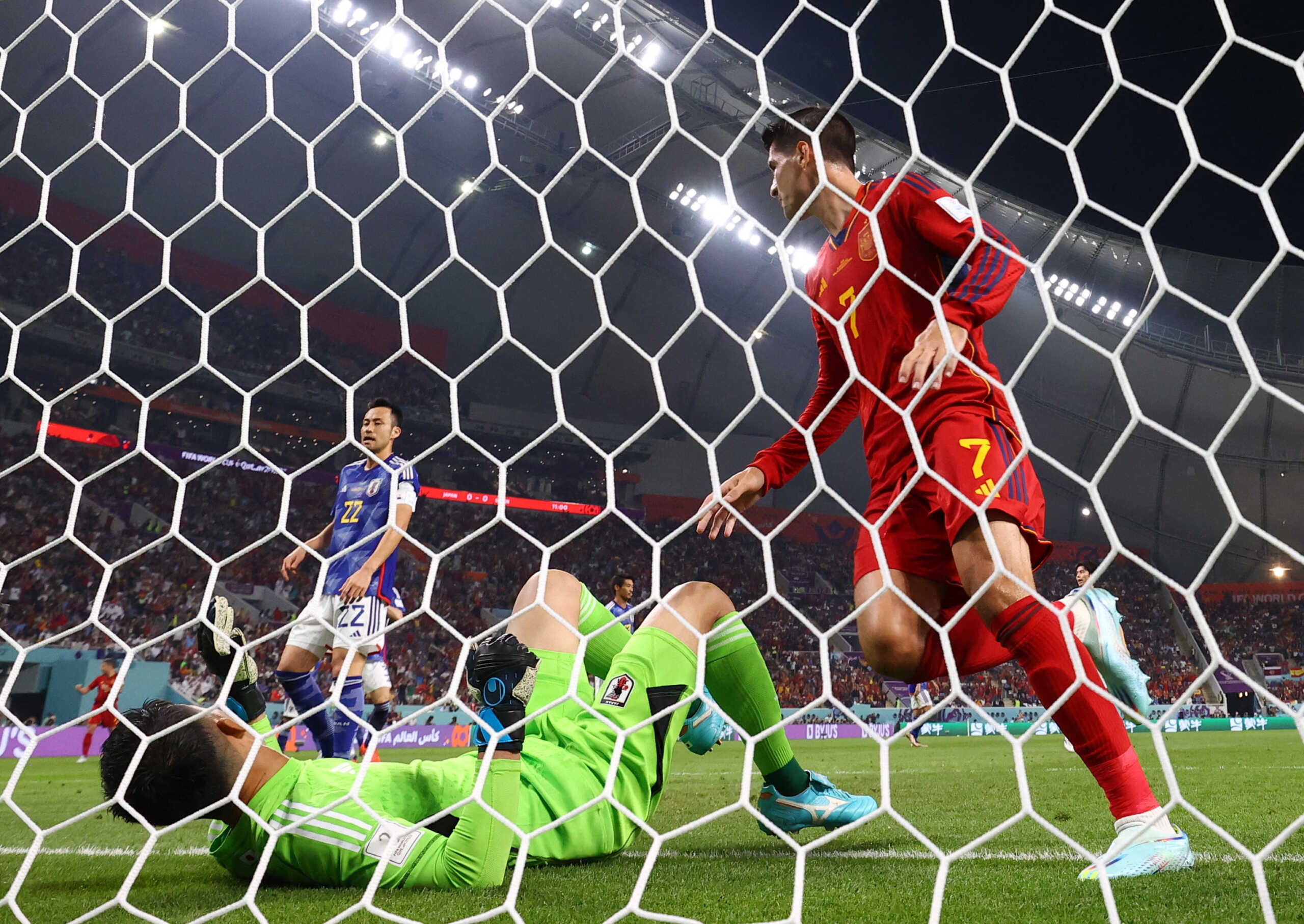 Soccer Football - FIFA World Cup Qatar 2022 - Group E - Japan v Spain - Khalifa International Stadium, Doha, Qatar - December 1, 2022 Spain's Alvaro Morata celebrates scoring their first goal as Japan's Shuichi Gonda reacts REUTERS