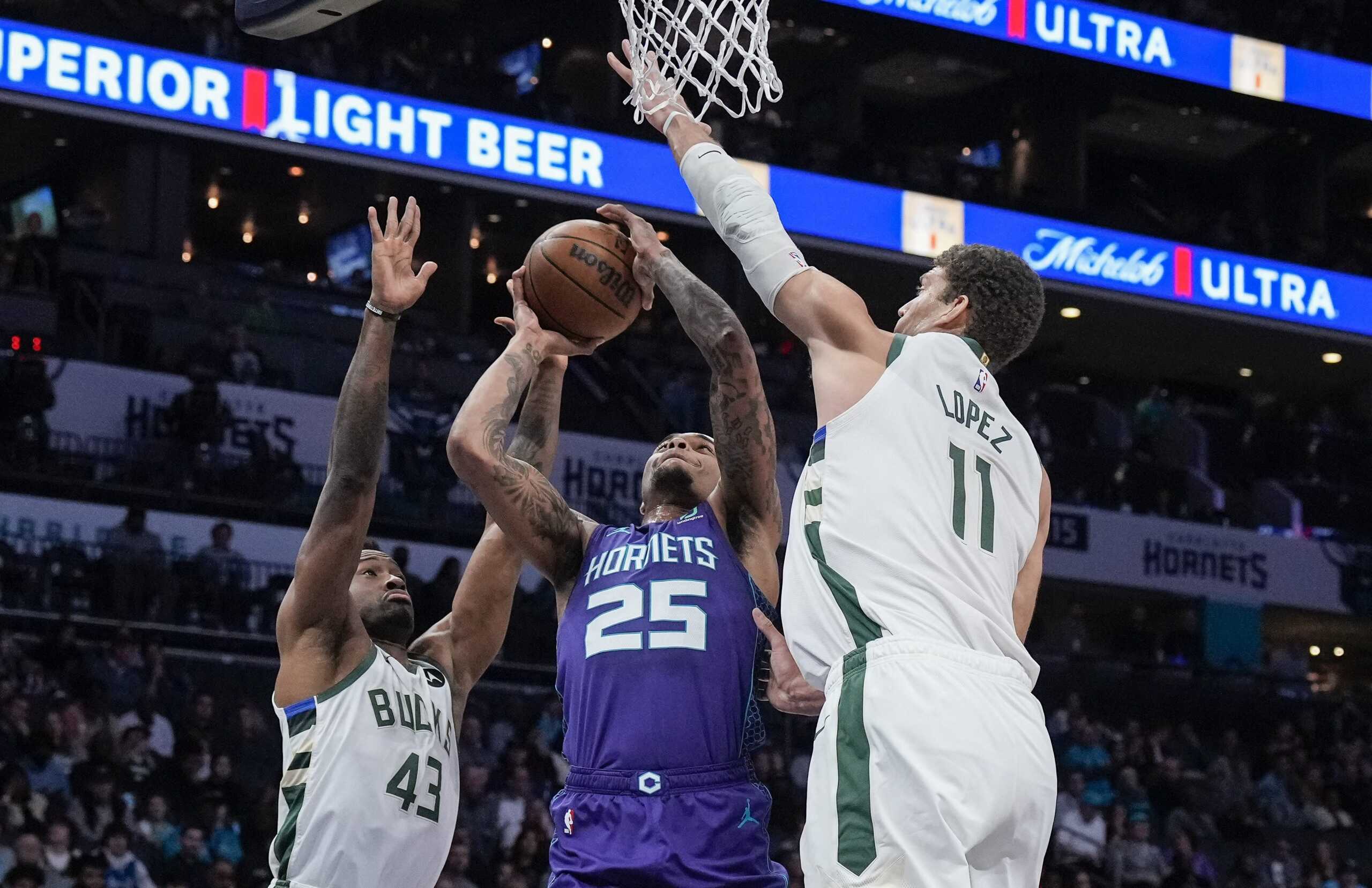 Dec 3, 2022; Charlotte, North Carolina, USA; Milwaukee Bucks center Brook Lopez (11) and forward Thanasis Antetokounmpo (43) look to block Charlotte Hornets forward P.J. Washington (25) during the first half at the Spectrum Center. Mandatory Credit: Jim Dedmon-USA TODAY Sports