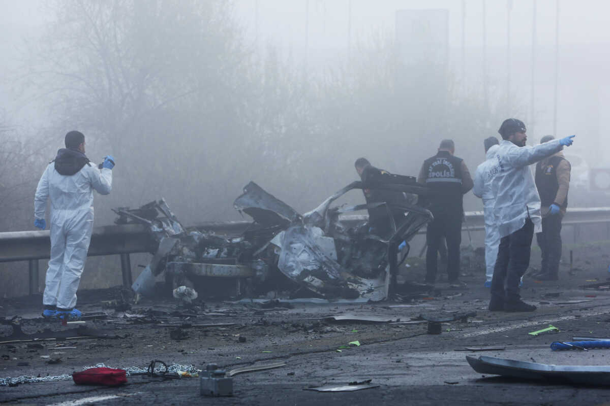 Police forensic experts examine the site after a bomb exploded in a roadside vehicle while a police minibus passed by, in Diyarbakir, Turkey December 16, 2022. REUTERS