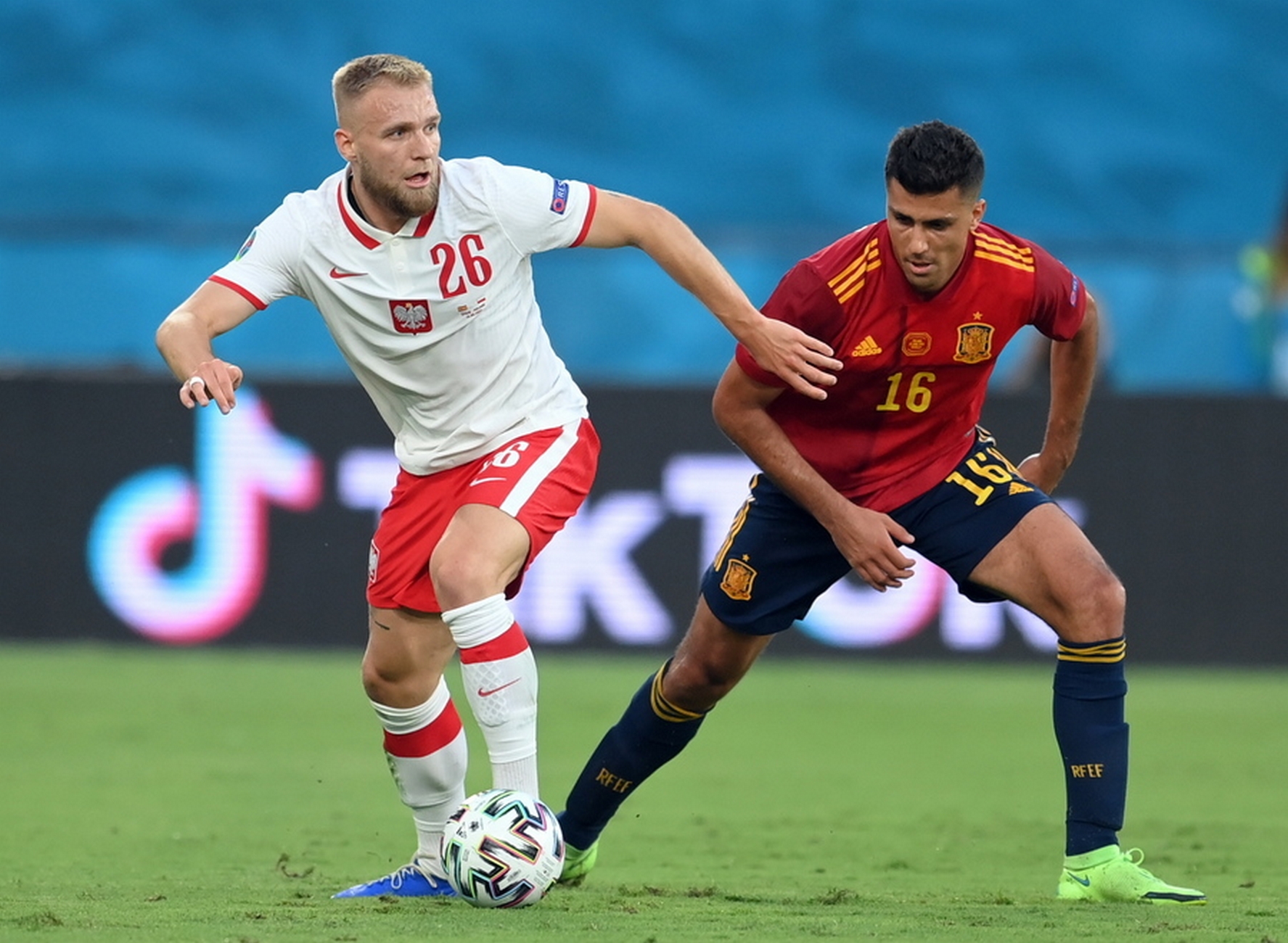epa09286839 Rodrigo of Spain in action against Tymoteusz Puchacz (L) of Poland during the UEFA EURO 2020 group E preliminary round soccer match between Spain and Poland in Seville, Spain, 19 June 2021.  EPA