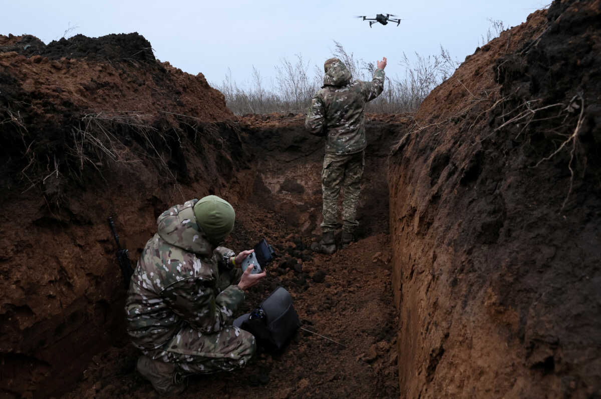Two soldiers with the 58th Independent Motorized Infantry Brigade of the Ukrainian Army who wanted to be identified as "Ghost", 24, and "Soap", 30, release their drone for a test flight, as Russia's invasion of Ukraine continues, near Bakhmut, Ukraine, November 25, 2022. REUTERS