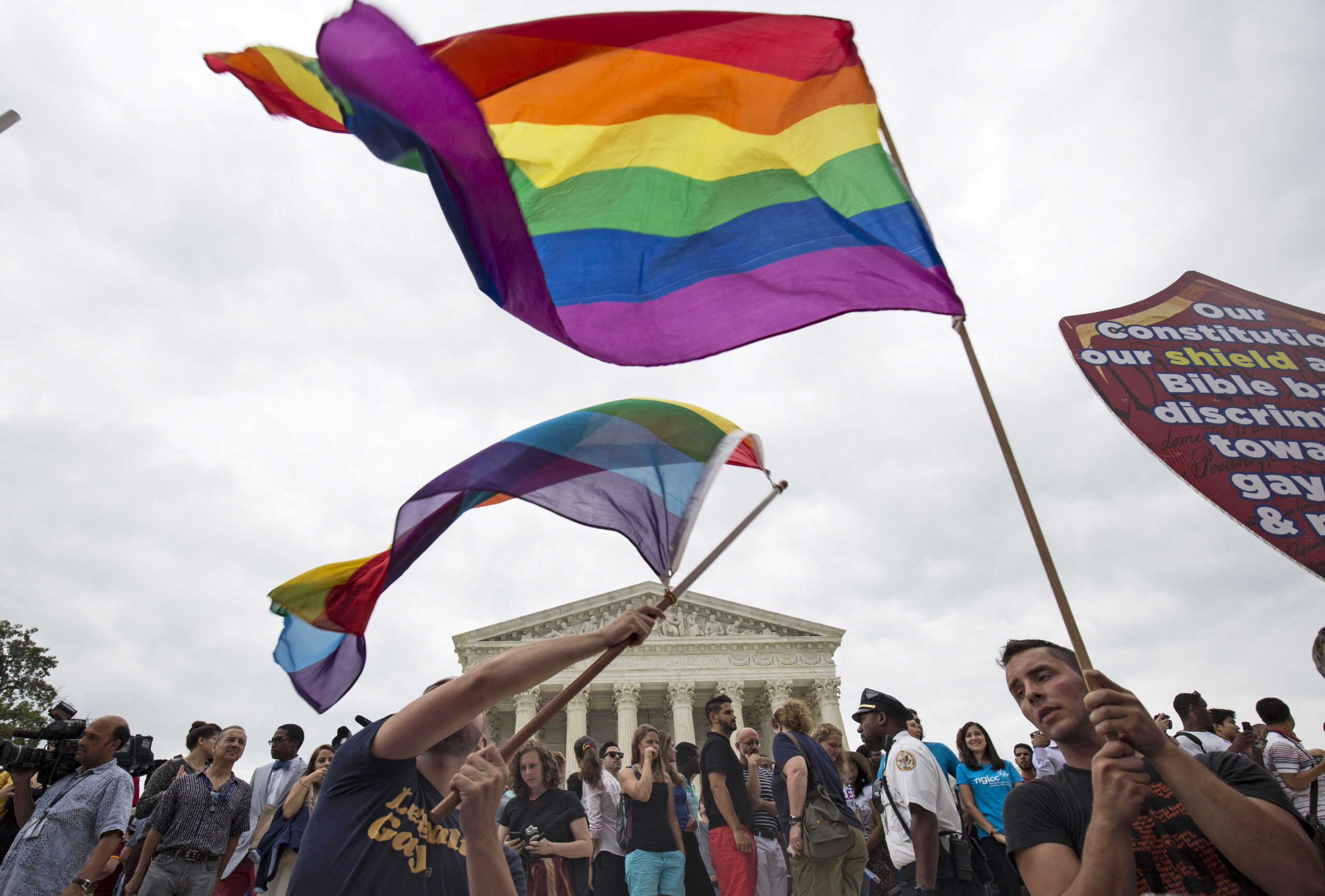 FILE PHOTO: Supporters of gay marriage wave the rainbow flag after the U.S. Supreme Court ruled that the U.S. Constitution provides same-sex couples the right to marry at the court building in Washington June 26, 2015. REUTERS