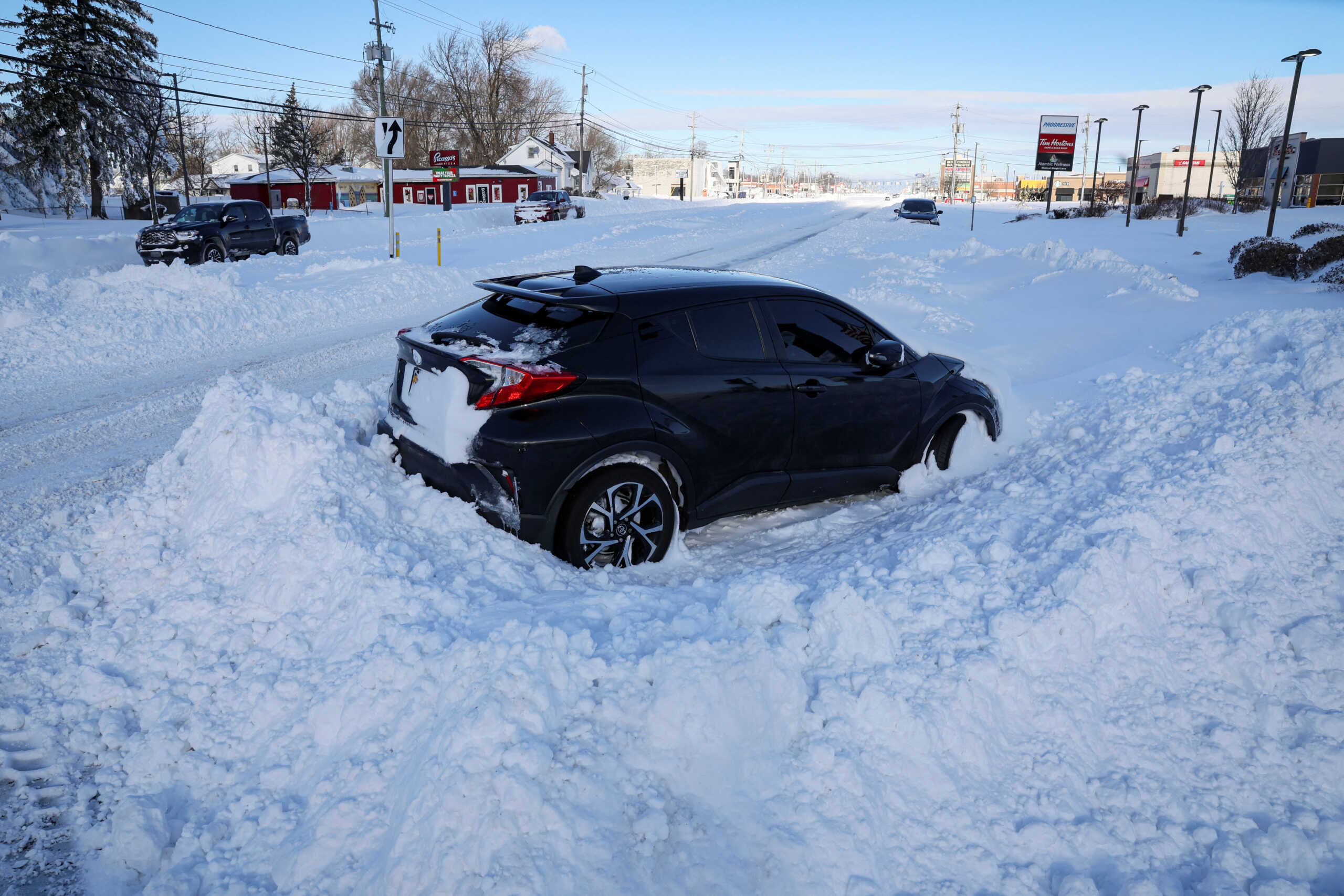 Vehicles are left stranded on the road following a winter storm that hit the Buffalo region on Main St. in Amherst, New York, U.S., December 25, 2022.  REUTERS