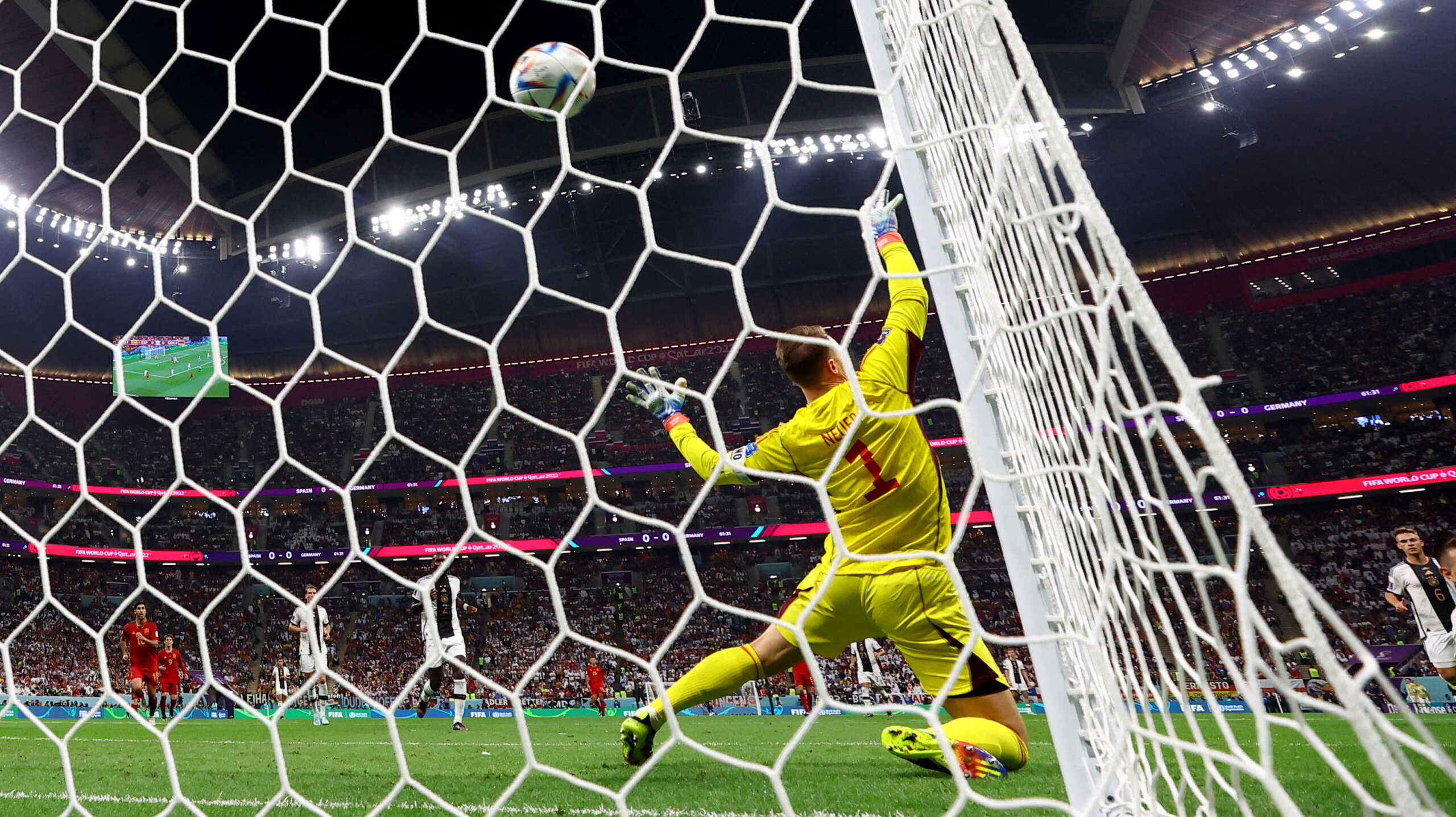 Soccer Football - FIFA World Cup Qatar 2022 - Group E - Spain v Germany - Al Bayt Stadium, Al Khor, Qatar - November 27, 2022 Spain's Alvaro Morata scores their first goal as Germany's Manuel Neuer attempts save REUTERS