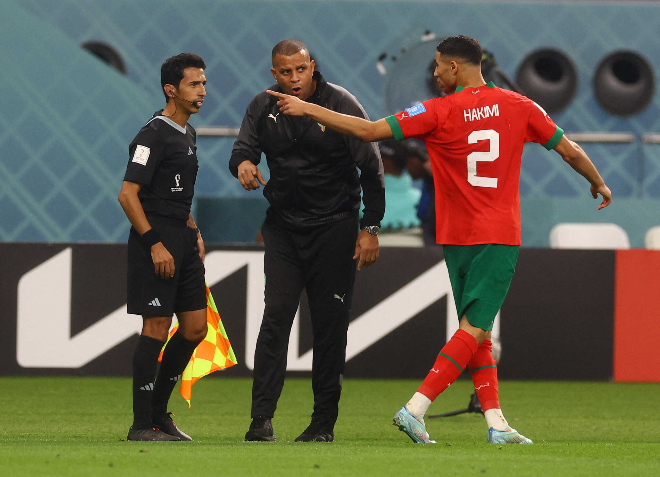 Soccer Football - FIFA World Cup Qatar 2022 - Third-Place Playoff - Croatia v Morocco - Khalifa International Stadium, Doha, Qatar - December 17, 2022 Assistant referee Taleb Al Marri talks to Morocco assistant coach Rachid Benmahmoud and Achraf Hakimi REUTERS