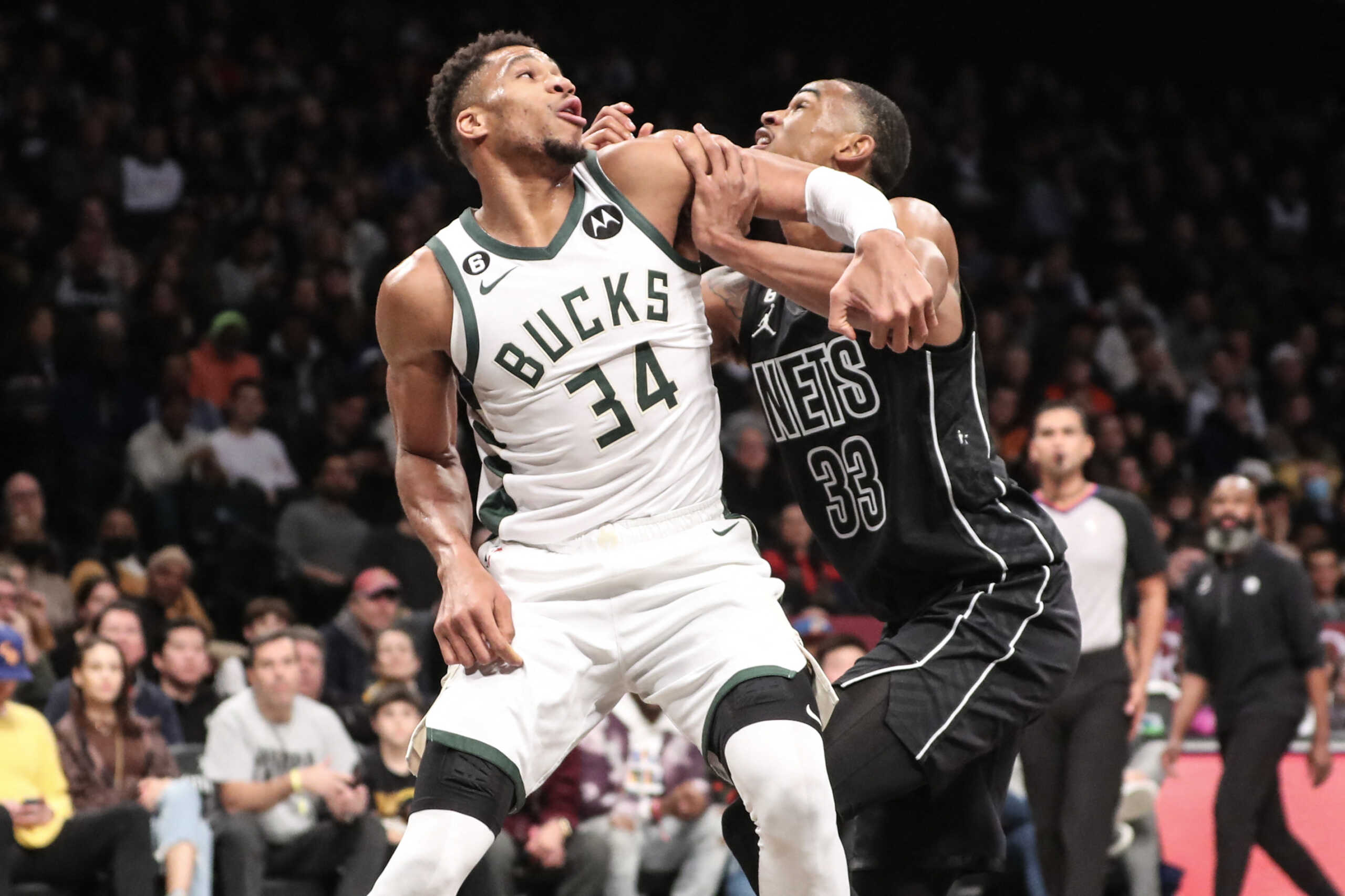 Dec 23, 2022; Brooklyn, New York, USA;  Milwaukee Bucks forward Giannis Antetokounmpo (34) and Brooklyn Nets center Nic Claxton (33) battle for position in the second quarter at Barclays Center. Mandatory Credit: Wendell Cruz-USA TODAY Sports