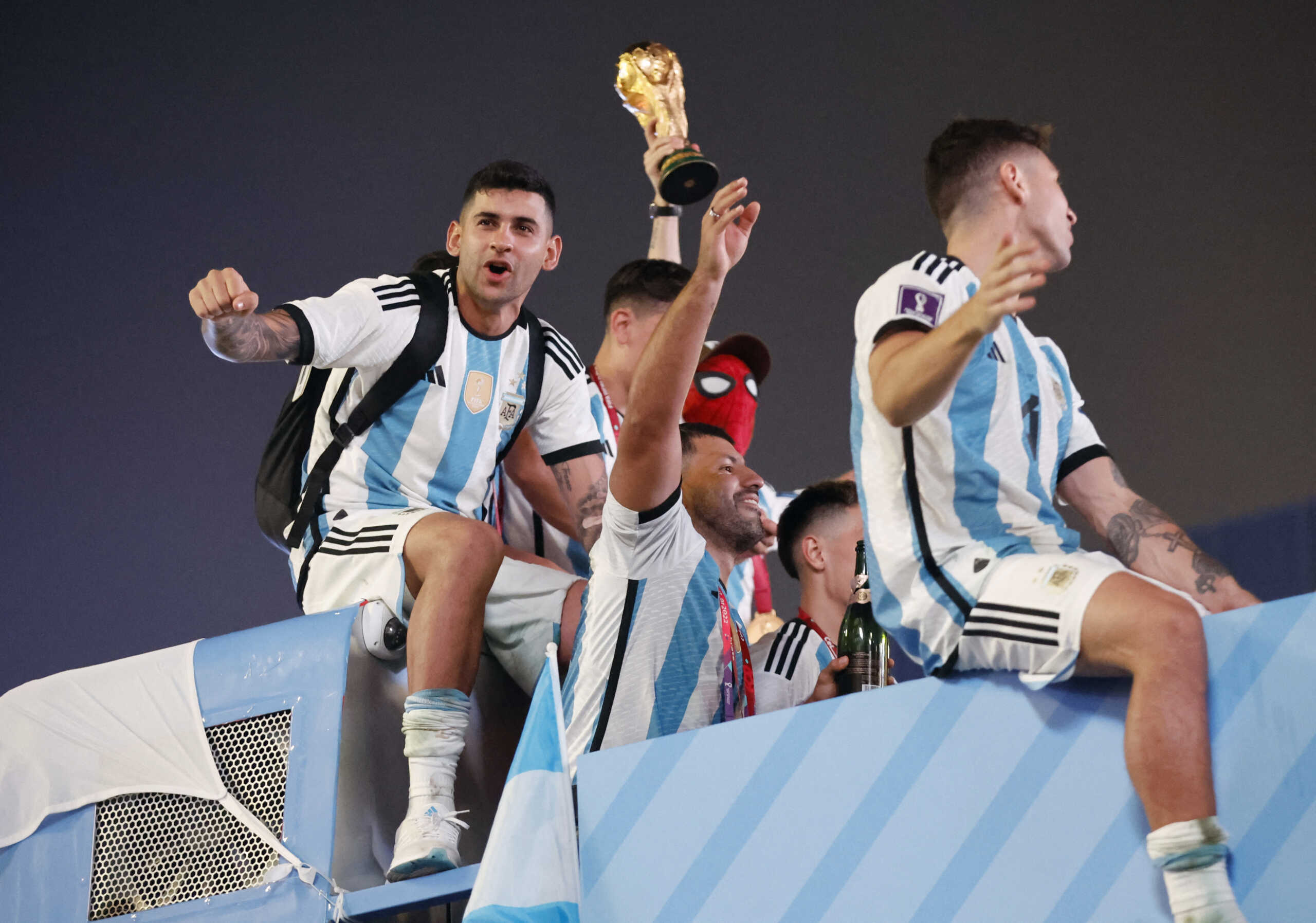 Soccer Football - FIFA World Cup Qatar 2022 - Final - Argentina v France - Lusail, Qatar - December 19, 2022 Argentina's Cristian Romero and teammates celebrate on a bus after winning the World Cup REUTERS