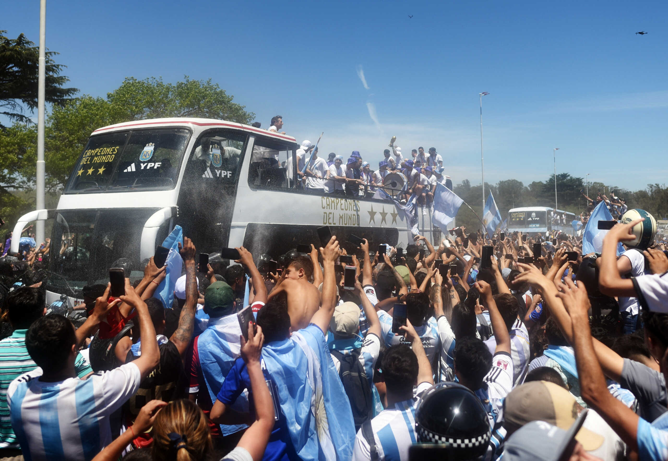 Soccer Football - FIFA World Cup Qatar 2022 - Argentina Victory Parade after winning the World Cup - Buenos Aires, Argentina - December 20, 2022  Argentina players are pictured on a bus with the World Cup trophy during the victory parade as fans celebrate REUTERS
