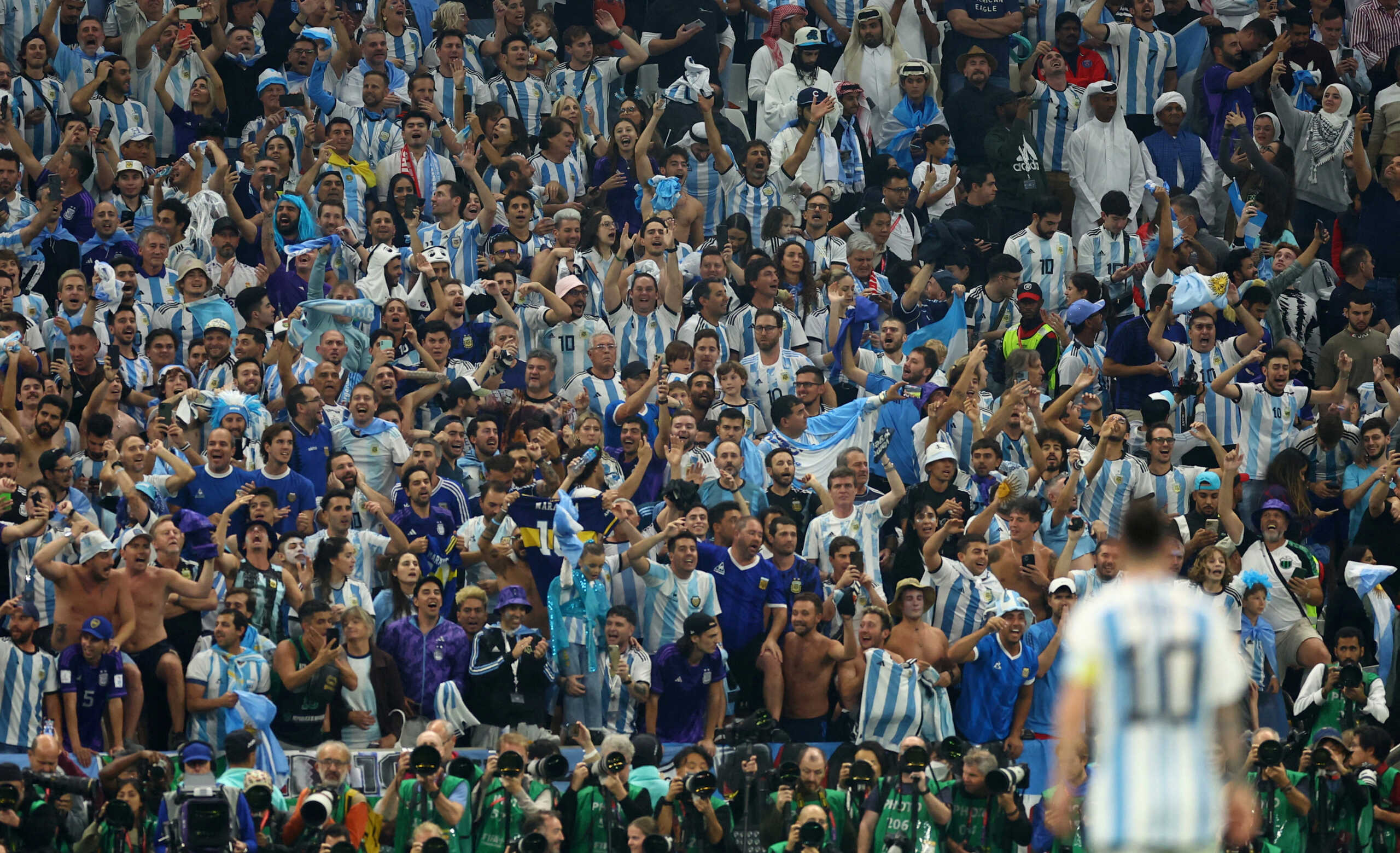 Soccer Football - FIFA World Cup Qatar 2022 - Semi Final - Argentina v Croatia - Lusail Stadium, Lusail, Qatar - December 13, 2022 Argentina fans in the stands react during the match with Lionel Messi pictured in the foreground REUTERS