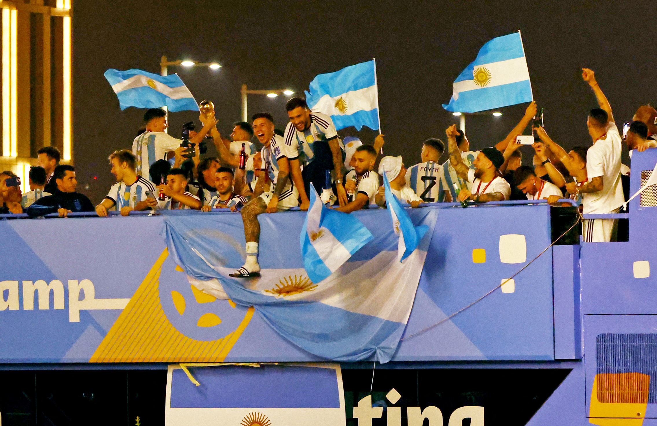 Soccer Football - FIFA World Cup Qatar 2022 - Final - Argentina v France - Lusail Stadium, Lusail, Qatar - December 19, 2022 Argentina players celebrate with the trophy on a bus outside the stadium after winning the World Cup REUTERS