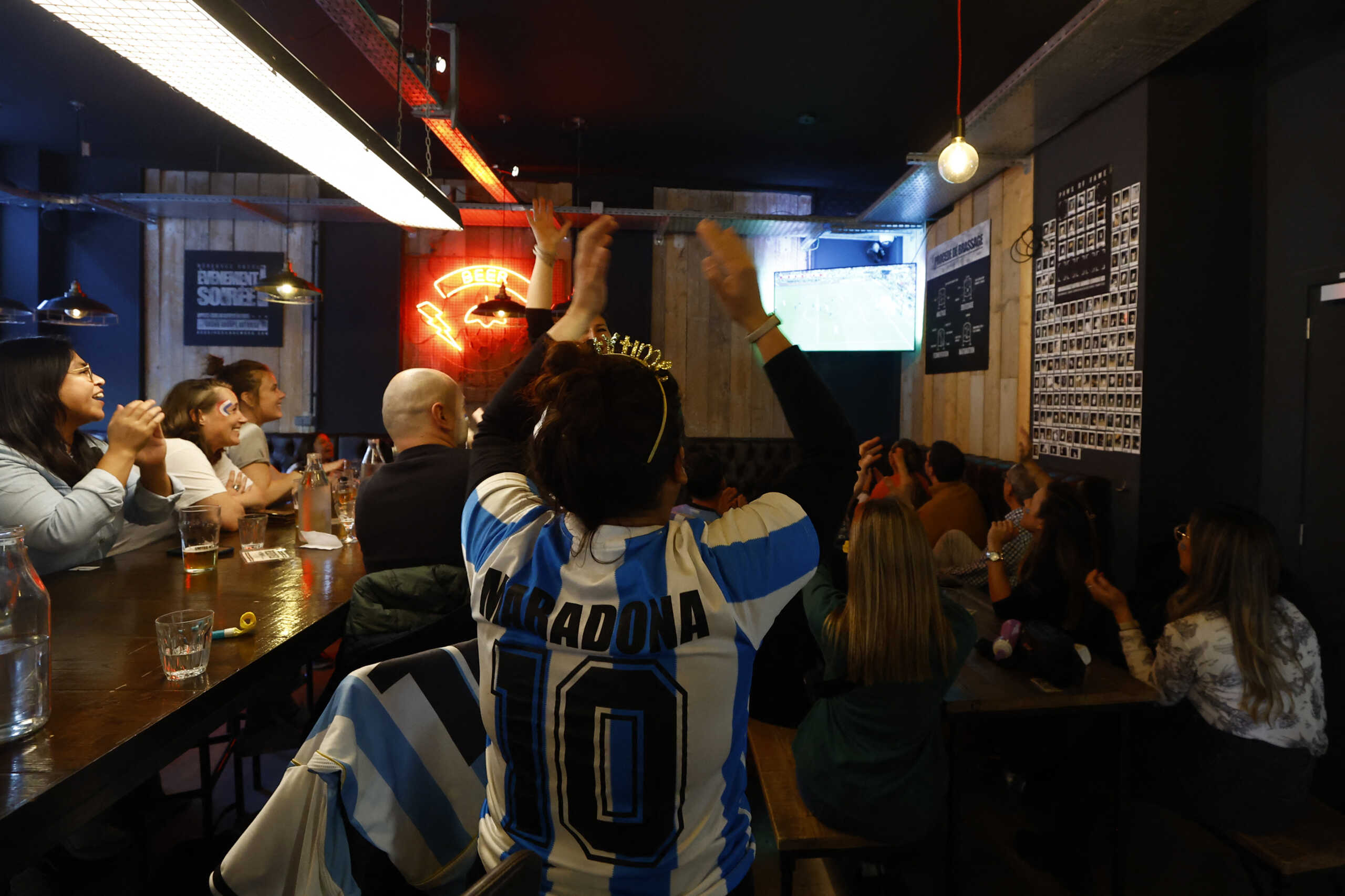 Soccer Football - FIFA World Cup Final Qatar 2022 - Fans in Nice watch Argentina v France - Nice, France - December 18, 2022 Argentina fans react at a pub in Nice during the final REUTERS