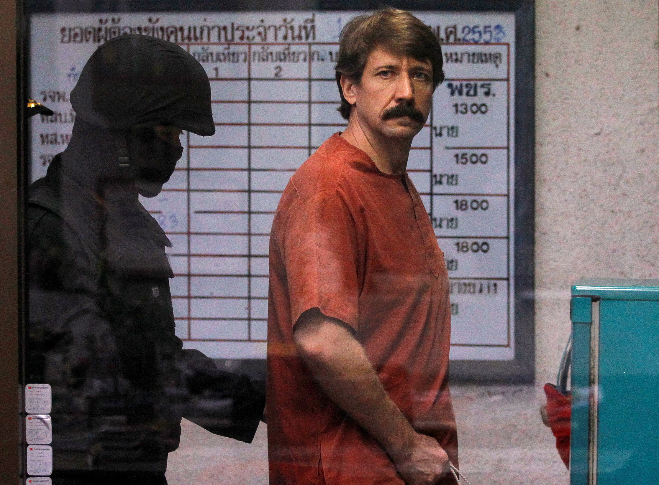 FILE PHOTO: Alleged arms smuggler Viktor Bout from Russia is escorted by a member of the special police unit as he arrives at a criminal court in Bangkok October 4, 2010. REUTERS