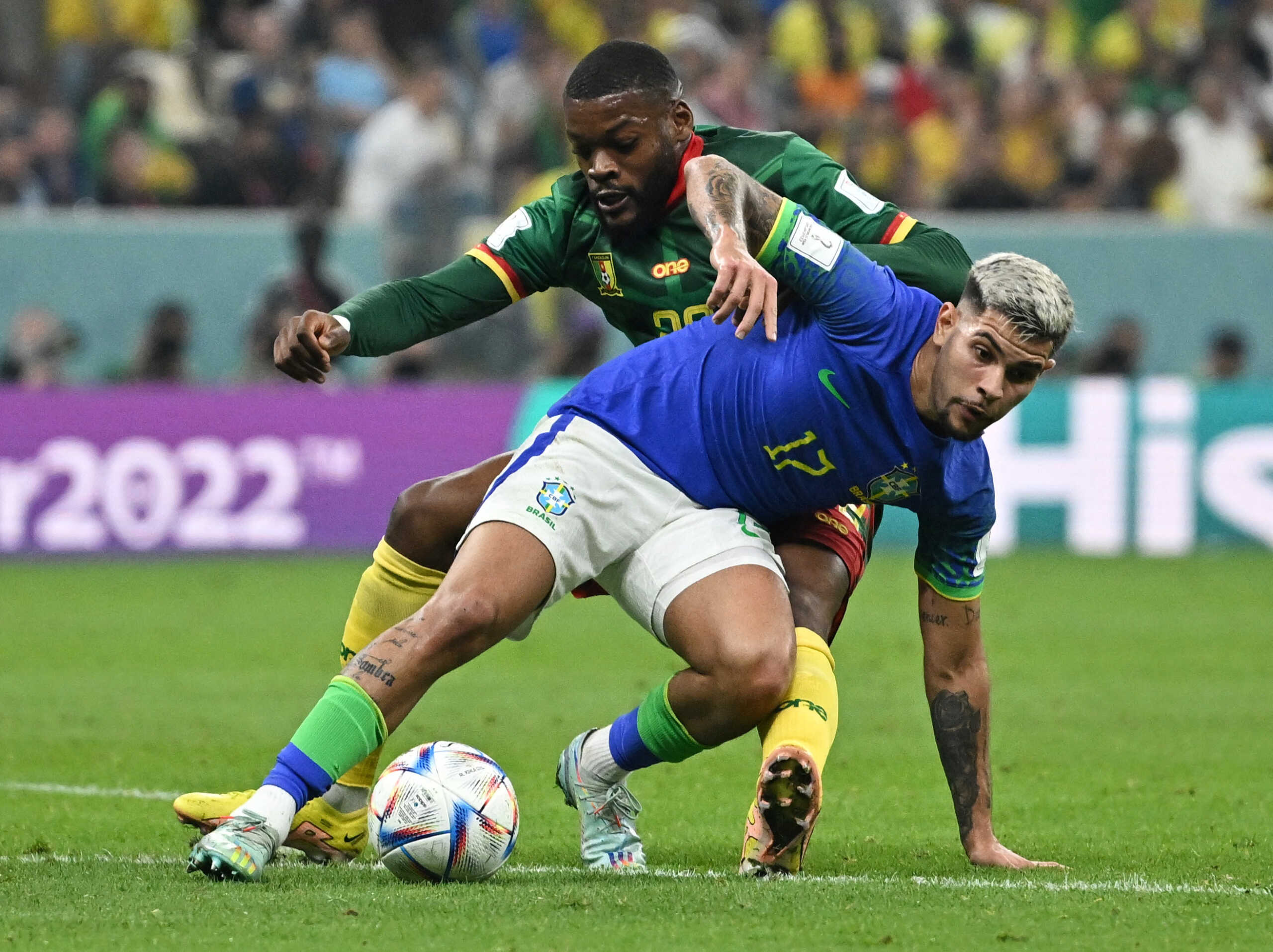 Soccer Football - FIFA World Cup Qatar 2022 - Group G - Cameroon v Brazil - Lusail Stadium, Lusail, Qatar - December 2, 2022 Brazil's Bruno Guimaraes in action with Cameroon's Olivier Ntcham REUTERS