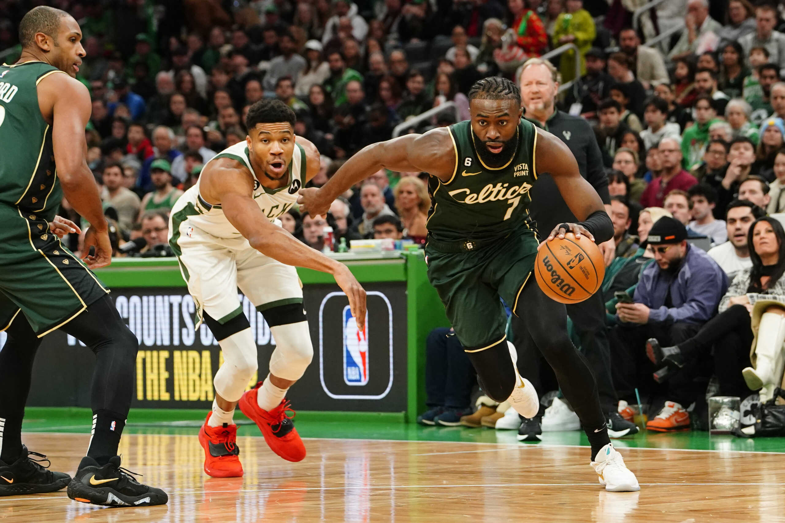 Dec 25, 2022; Boston, Massachusetts, USA;  Boston Celtics shooting guard Jaylen Brown (7) drives the ball against Milwaukee Bucks power forward Giannis Antetokounmpo (34) during the 1st quarter at TD Garden. Mandatory Credit: Gregory Fisher-USA TODAY Sports
