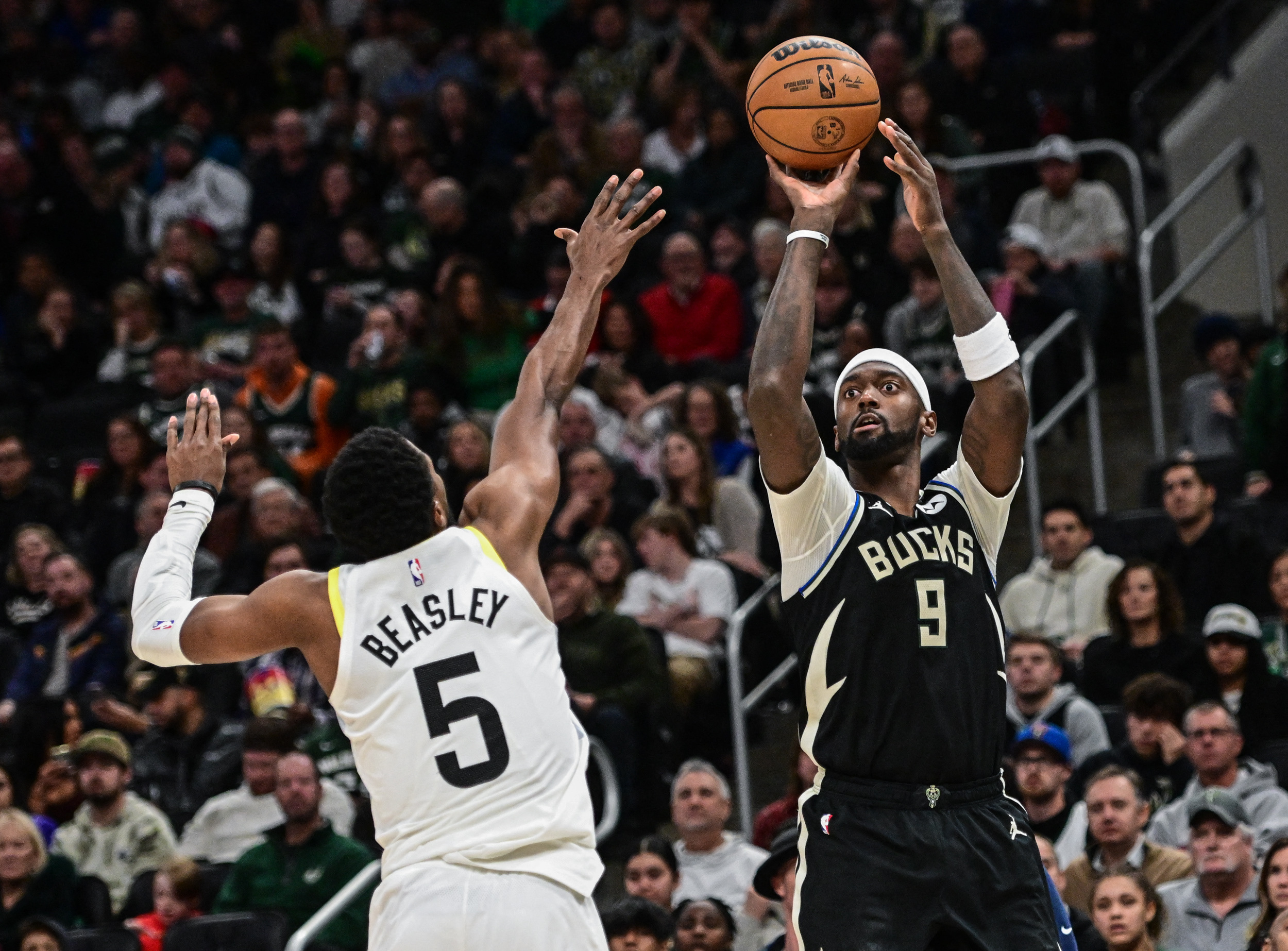 Dec 17, 2022; Milwaukee, Wisconsin, USA; Milwaukee Bucks forward Bobby Portis (9) shoots the ball against Utah Jazz guard Malik Beasley (5) in the fourth quarter at Fiserv Forum. Mandatory Credit: Benny Sieu-USA TODAY Sports