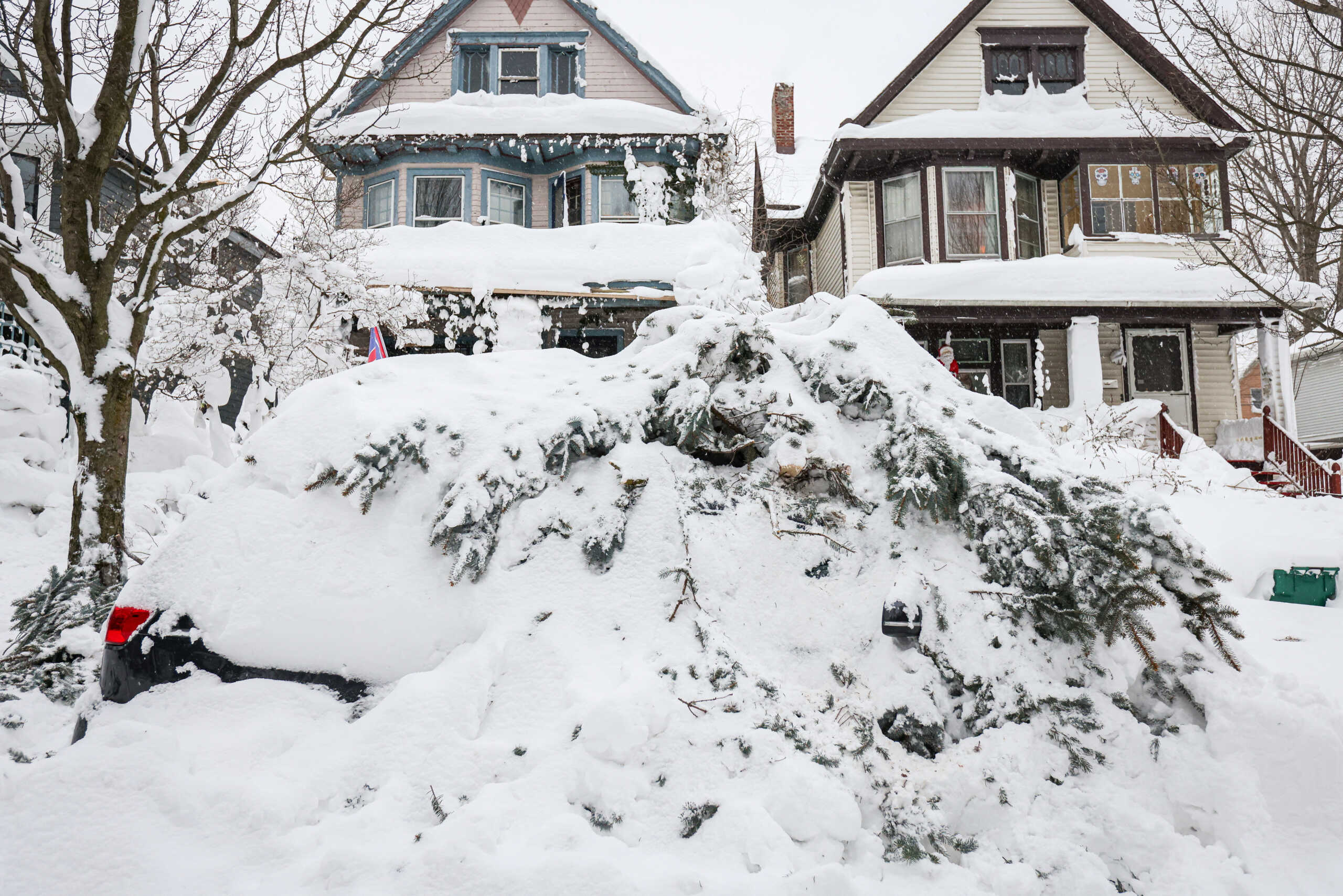 Remnants of a fallen tree remain on the roof of a vehicle following a winter storm in Buffalo, New York, U.S., December 27, 2022.  REUTERS