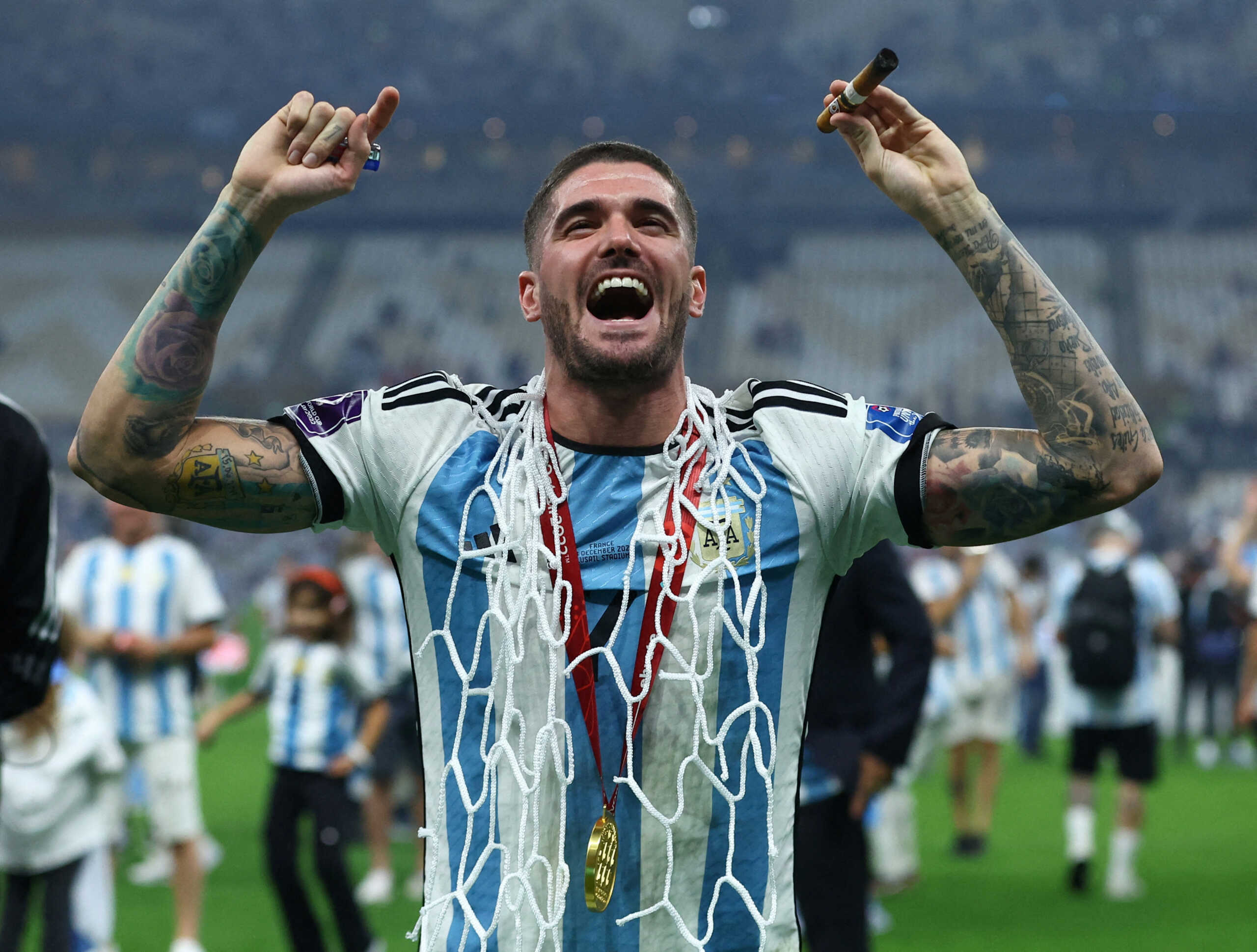 Soccer Football - FIFA World Cup Qatar 2022 - Final - Argentina v France - Lusail Stadium, Lusail, Qatar - December 18, 2022 Argentina's Rodrigo De Paul celebrates with his medal and part of the goal net after winning the World Cup REUTERS
