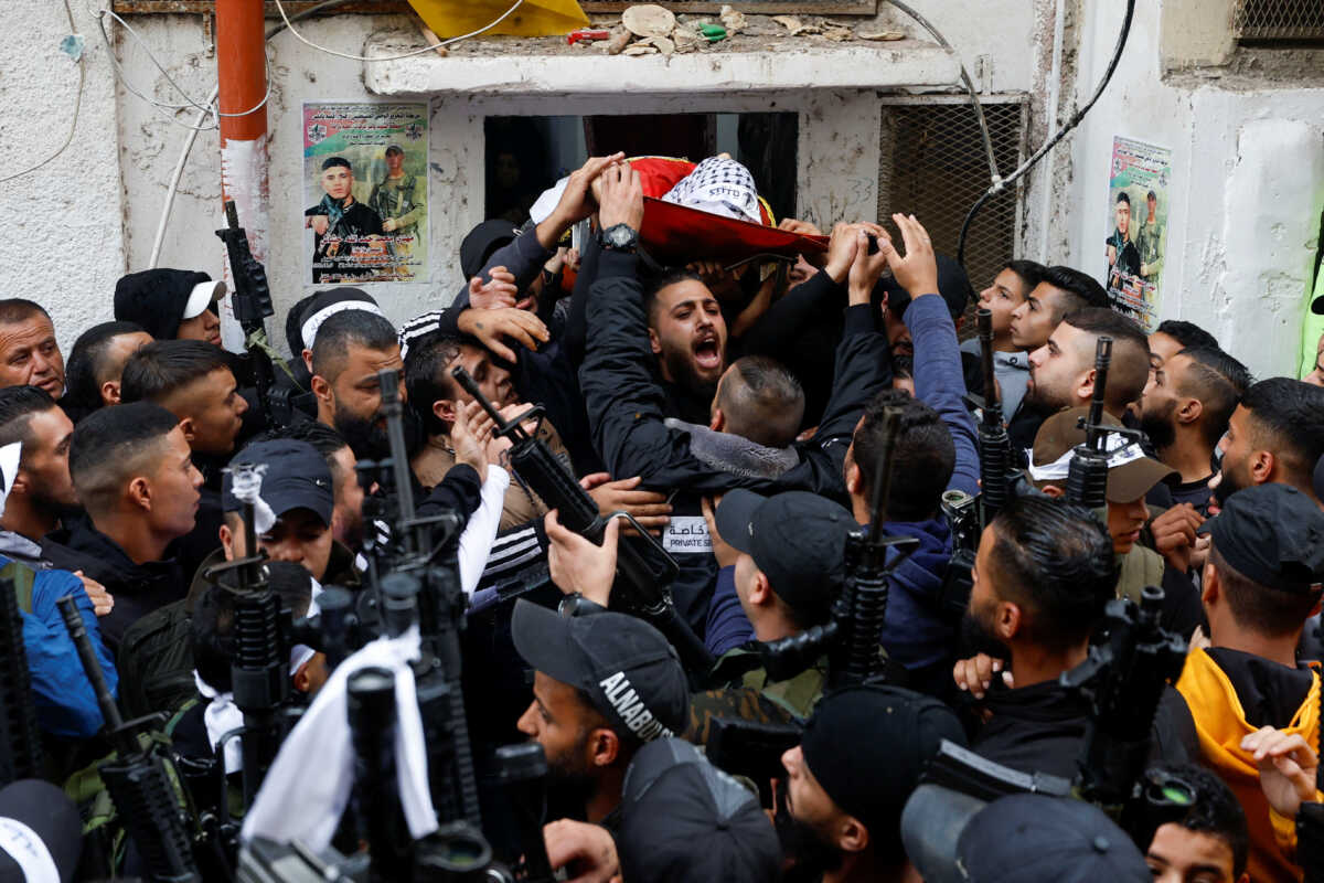 Mourners carry the body of Palestinian Mahdi Hashash during his funeral in Nablus in the Israeli-occupied West Bank November 9, 2022. REUTERS