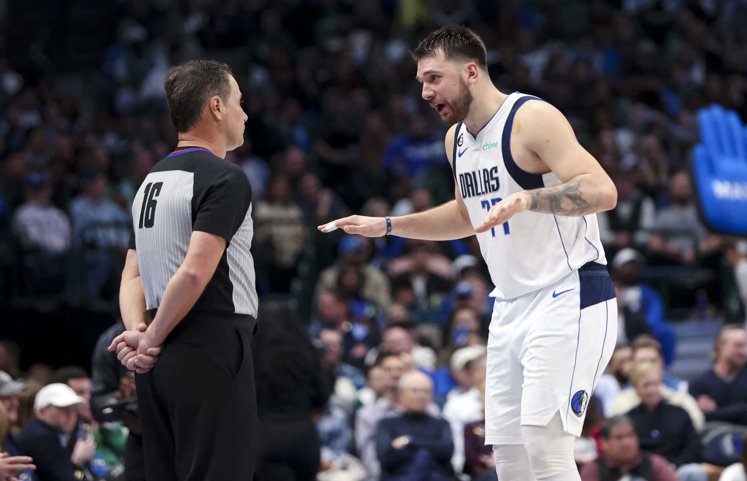 Dec 12, 2022; Dallas, Texas, USA; Dallas Mavericks guard Luka Doncic (77) speaks with referee David Guthrie (16) during the second half against the Oklahoma City Thunder at American Airlines Center. Mandatory Credit: Kevin Jairaj-USA TODAY Sports