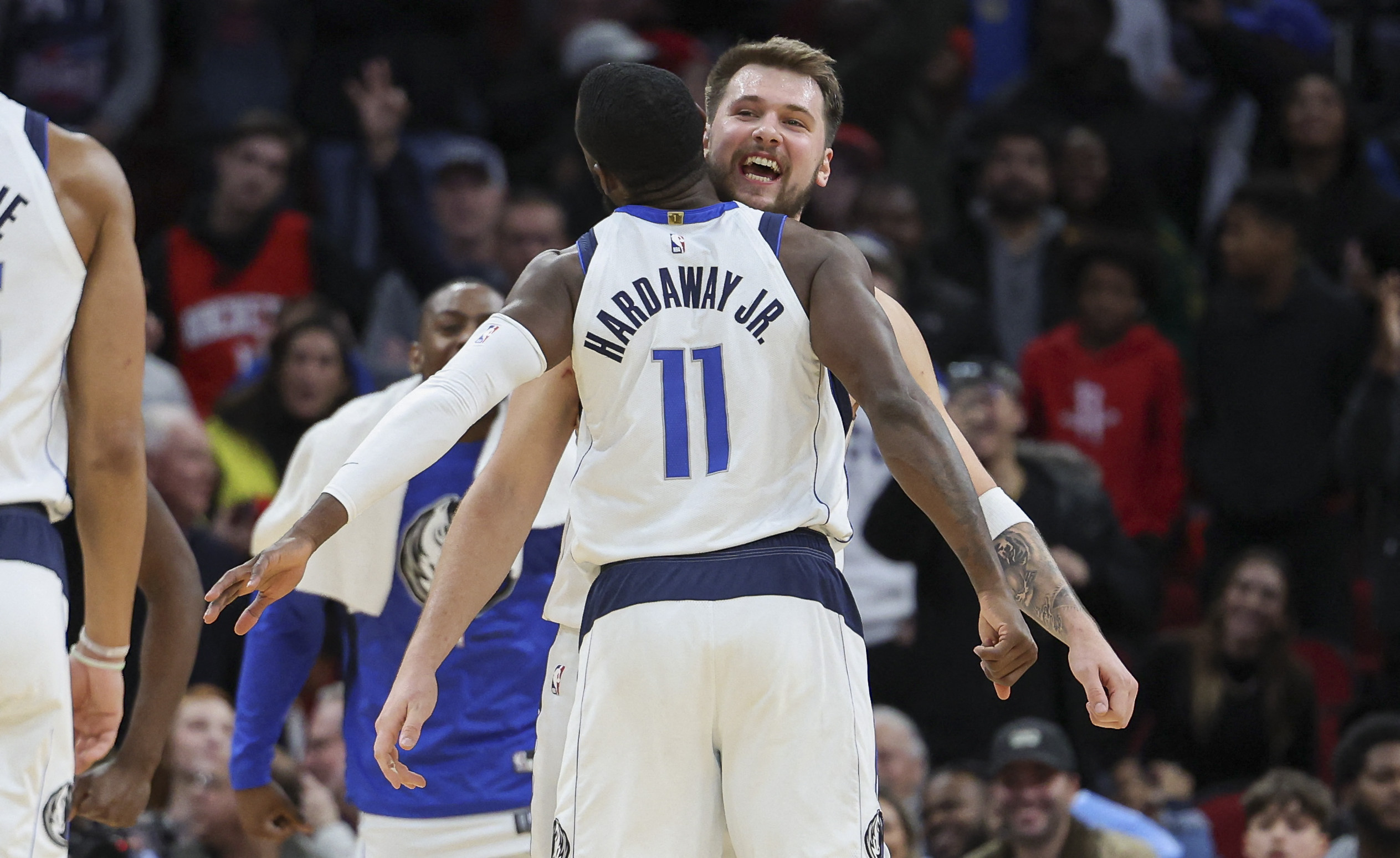 Dec 23, 2022; Houston, Texas, USA; Dallas Mavericks guard Luka Doncic (77) celebrates with forward Tim Hardaway Jr. (11) after scoring a basket during the fourth quarter against the Houston Rockets at Toyota Center. Mandatory Credit: Troy Taormina-USA TODAY Sports