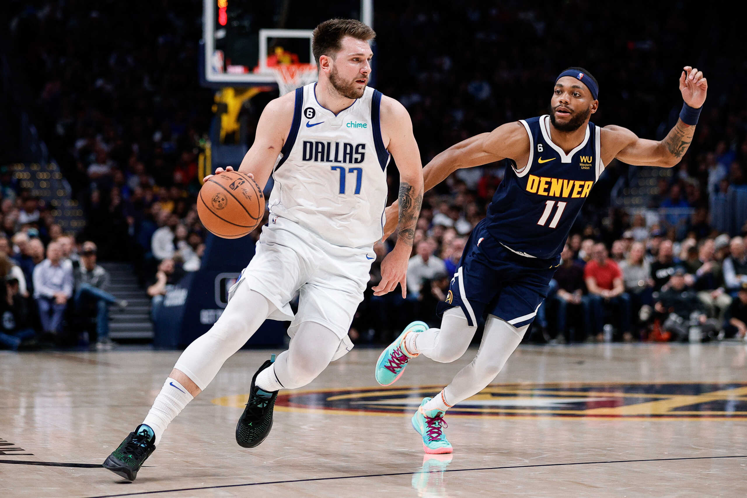 Dec 6, 2022; Denver, Colorado, USA; Dallas Mavericks guard Luka Doncic (77) controls the ball as Denver Nuggets forward Bruce Brown (11) guards in the third quarter at Ball Arena. Mandatory Credit: Isaiah J. Downing-USA TODAY Sports