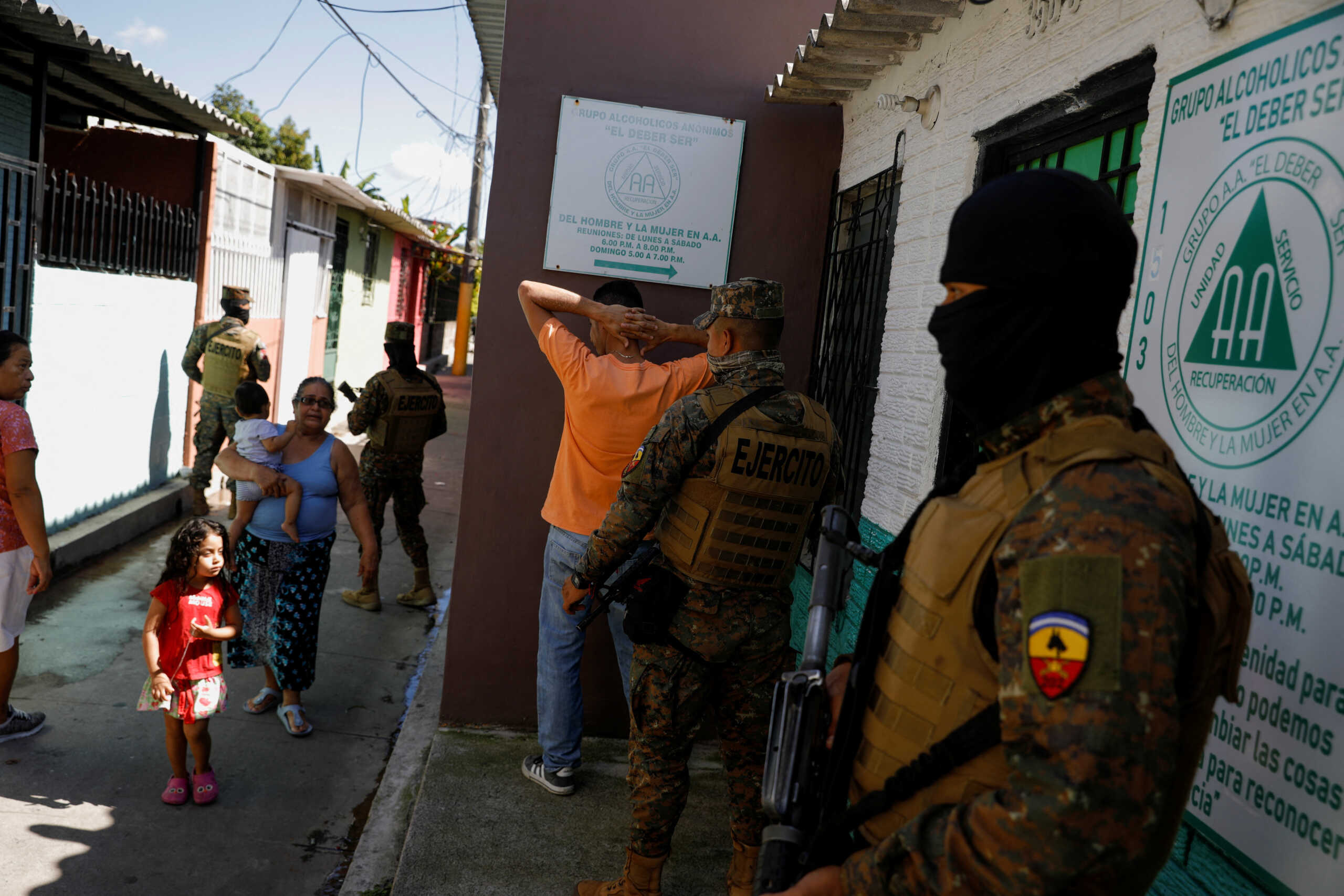 Soldiers stop a man to check his identification and mobile phone in the suburb of Soyapango, after El Salvador's President Nayib Bukele announced the deployment of 10,000 security forces to the troubled area which for years has been considered a stronghold of the violent Mara Salvatrucha and Barrio 18 gangs, in San Salvador, El Salvador December 3, 2022. REUTERS