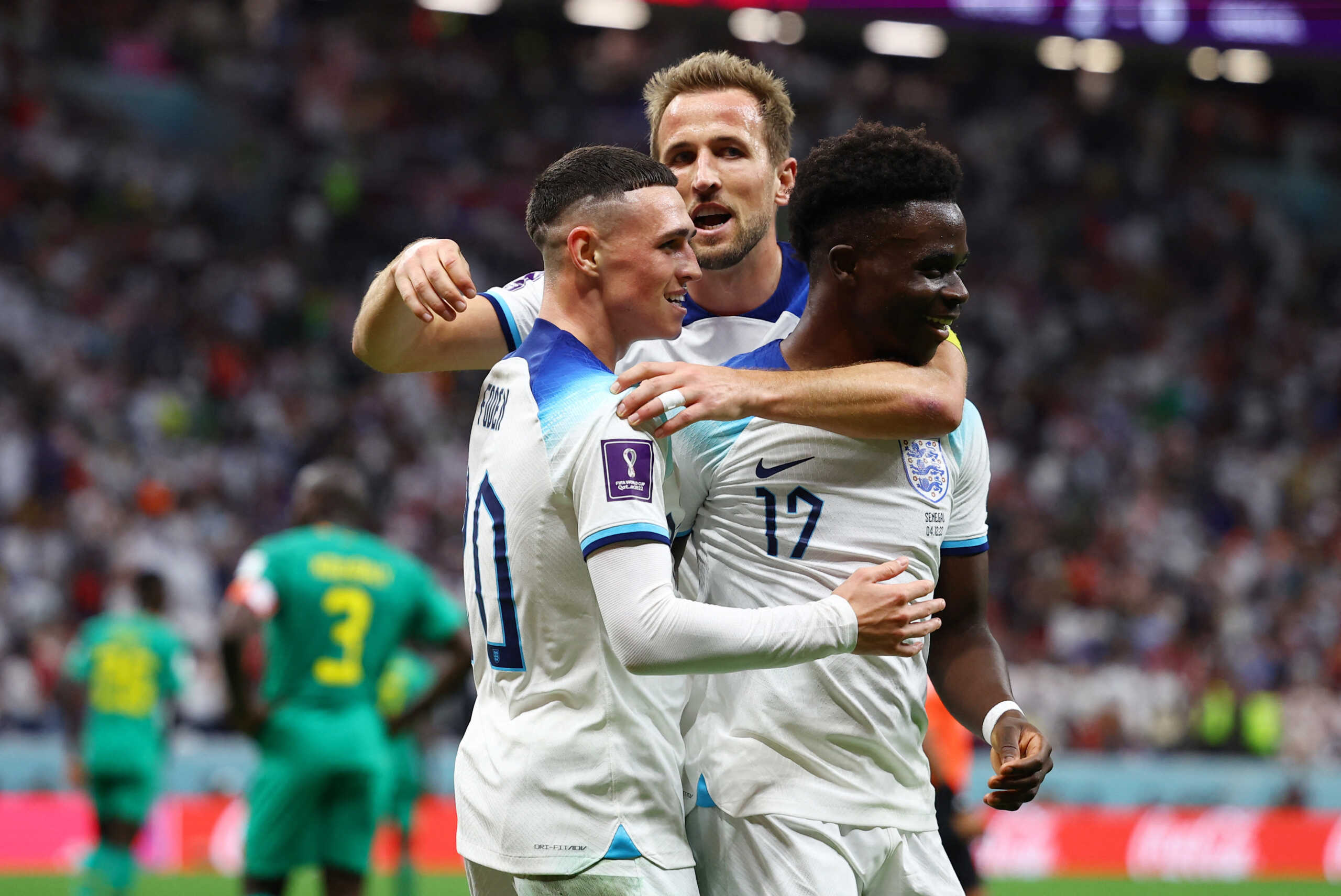 Soccer Football - FIFA World Cup Qatar 2022 - Round of 16 - England v Senegal - Al Bayt Stadium, Al Khor, Qatar - December 4, 2022 England's Bukayo Saka celebrates scoring their third goal with Harry Kane and Phil Foden REUTERS