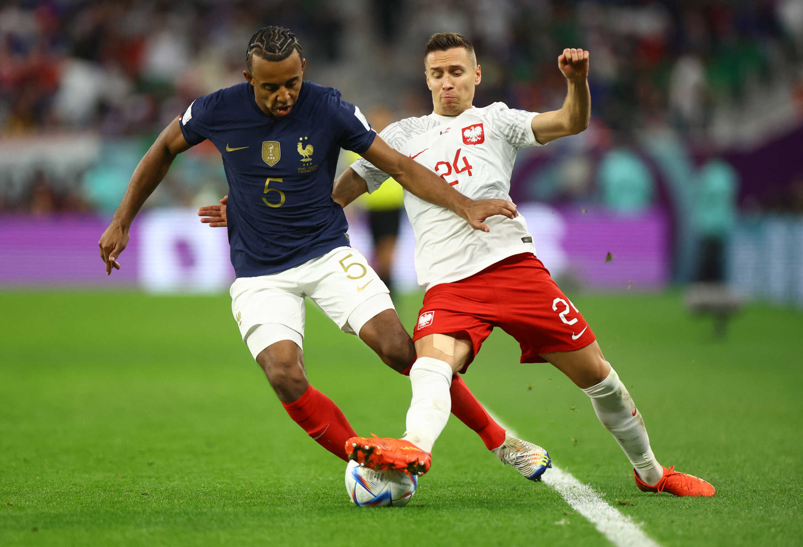 Soccer Football - FIFA World Cup Qatar 2022 - Round of 16 - France v Poland - Al Thumama Stadium, Doha, Qatar - December 4, 2022 France's Jules Kounde in action with Poland's Przemyslaw Frankowski REUTERS