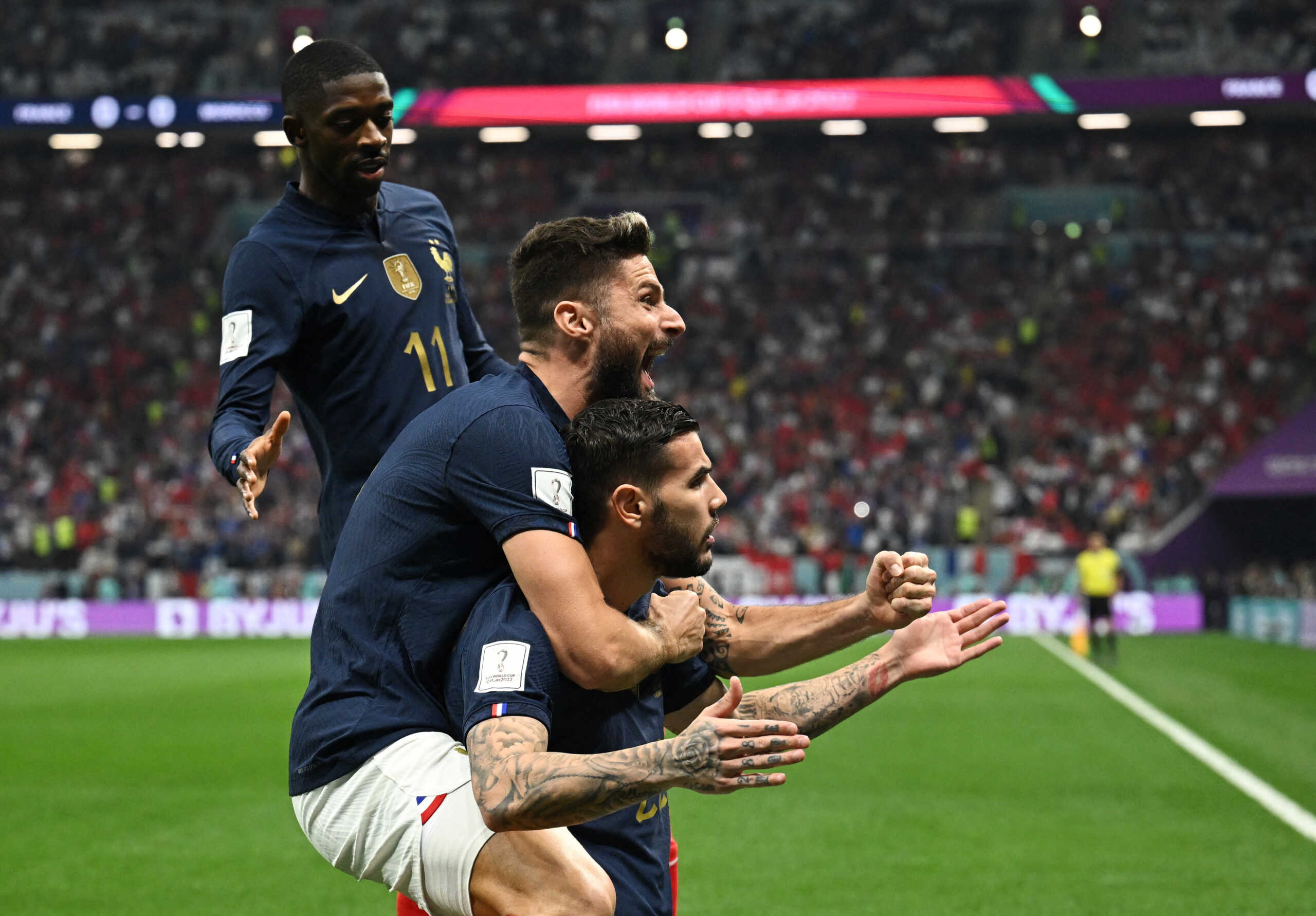 Soccer Football - FIFA World Cup Qatar 2022 - Semi Final - France v Morocco - Al Bayt Stadium, Al Khor, Qatar - December 14, 2022 France's Theo Hernandez celebrates scoring their first goal with Olivier Giroud and Ousmane Dembele REUTERS
