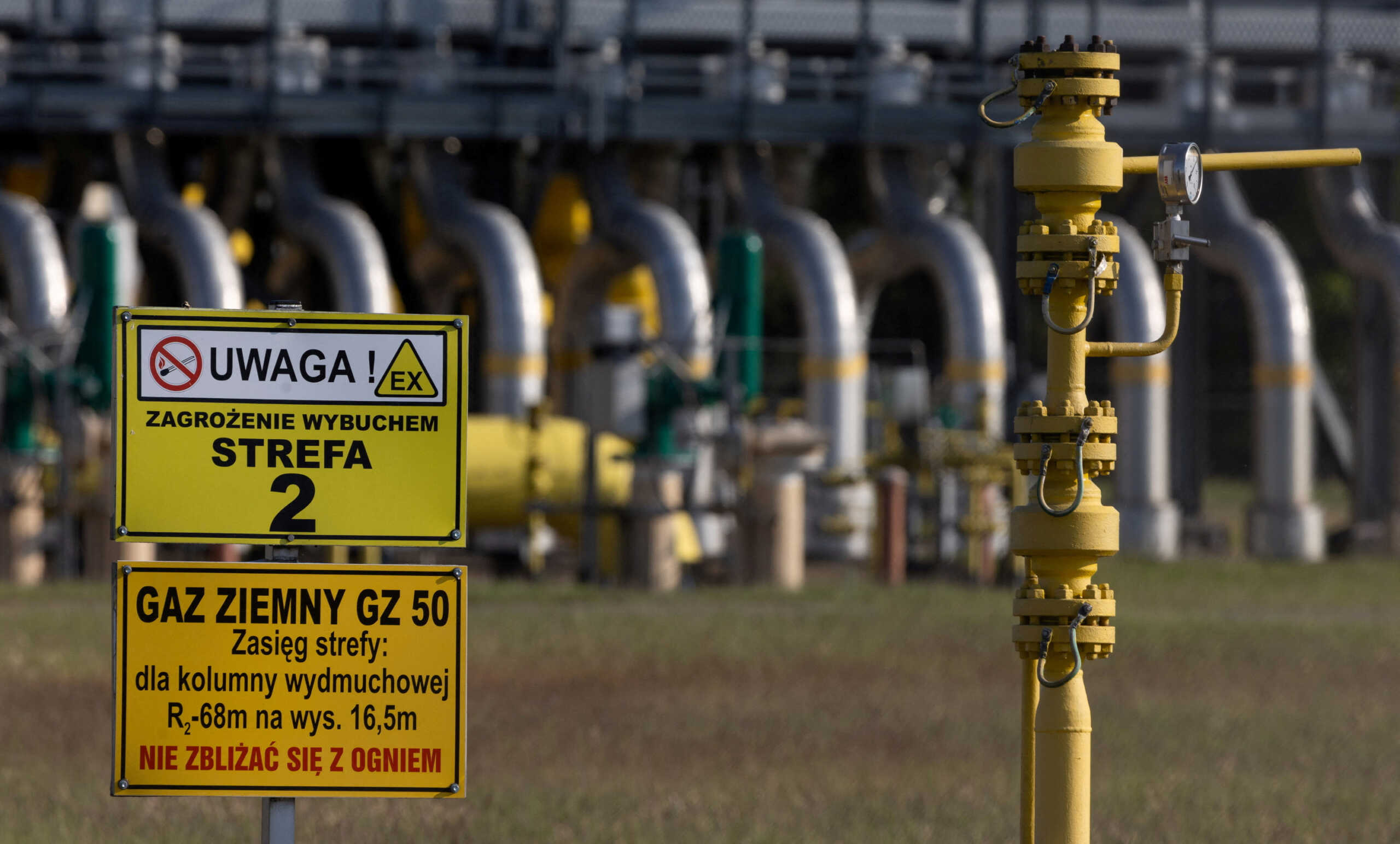 FILE PHOTO: Warning signs are pictured in front of the gas compressor station, a part of Polish section of the Yamal pipeline that links Russia with western Europe which is owned by a joint venture of Gazprom and PGNiG but it is operated by Poland's state-owned gas transmission company Gaz-System, in Gabinek near Wloclawek, Poland May 23, 2022. The signs read: "Attention! Explosion risk. Zone 2" and "Natural gas. Keep fire away." REUTERS