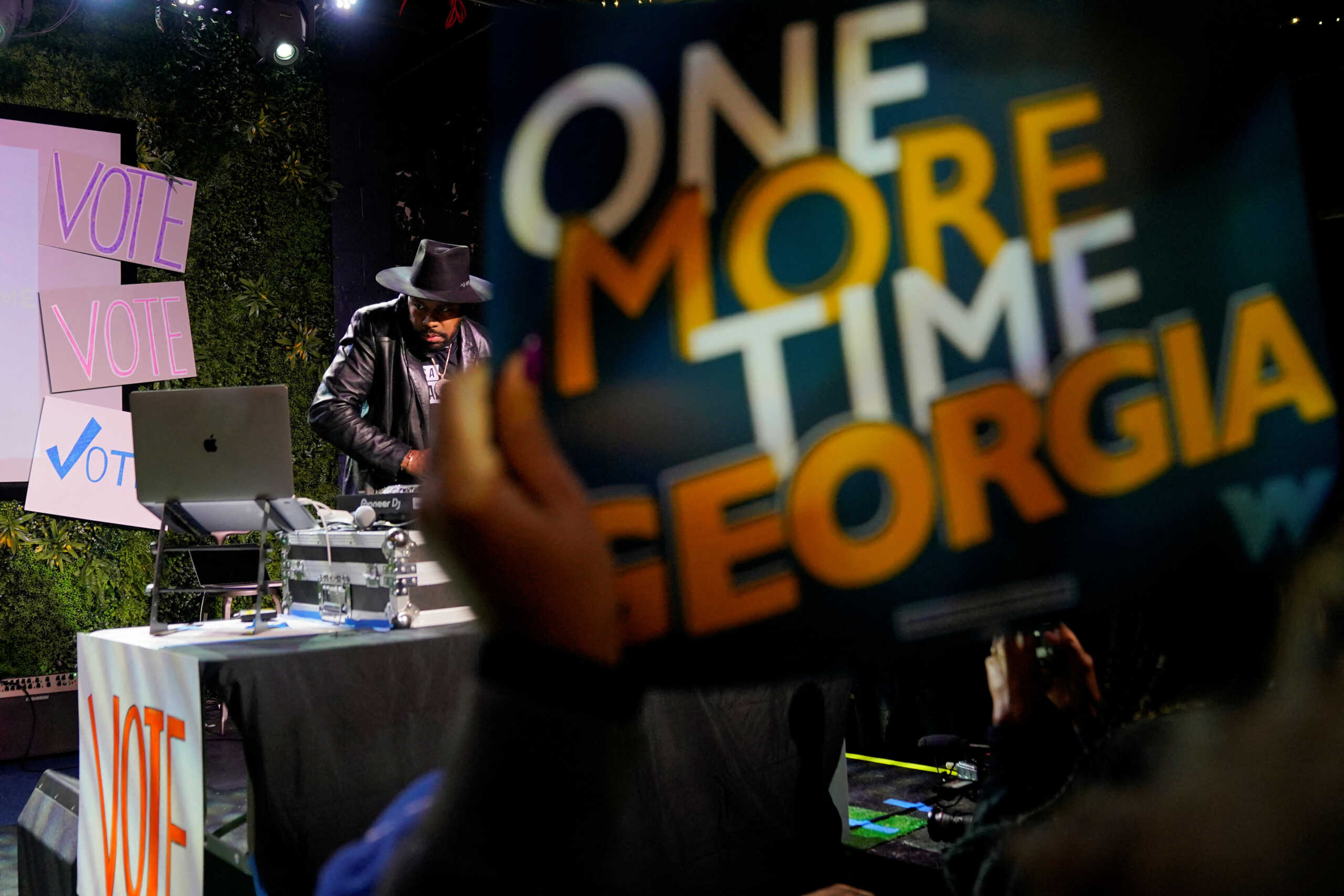 A DJ plays music during the final midterm runoff election campaign rally for Reverend Raphael Warnock, Democratic Senator for Georgia, in Atlanta, Georgia, U.S., December 5, 2022. REUTERS