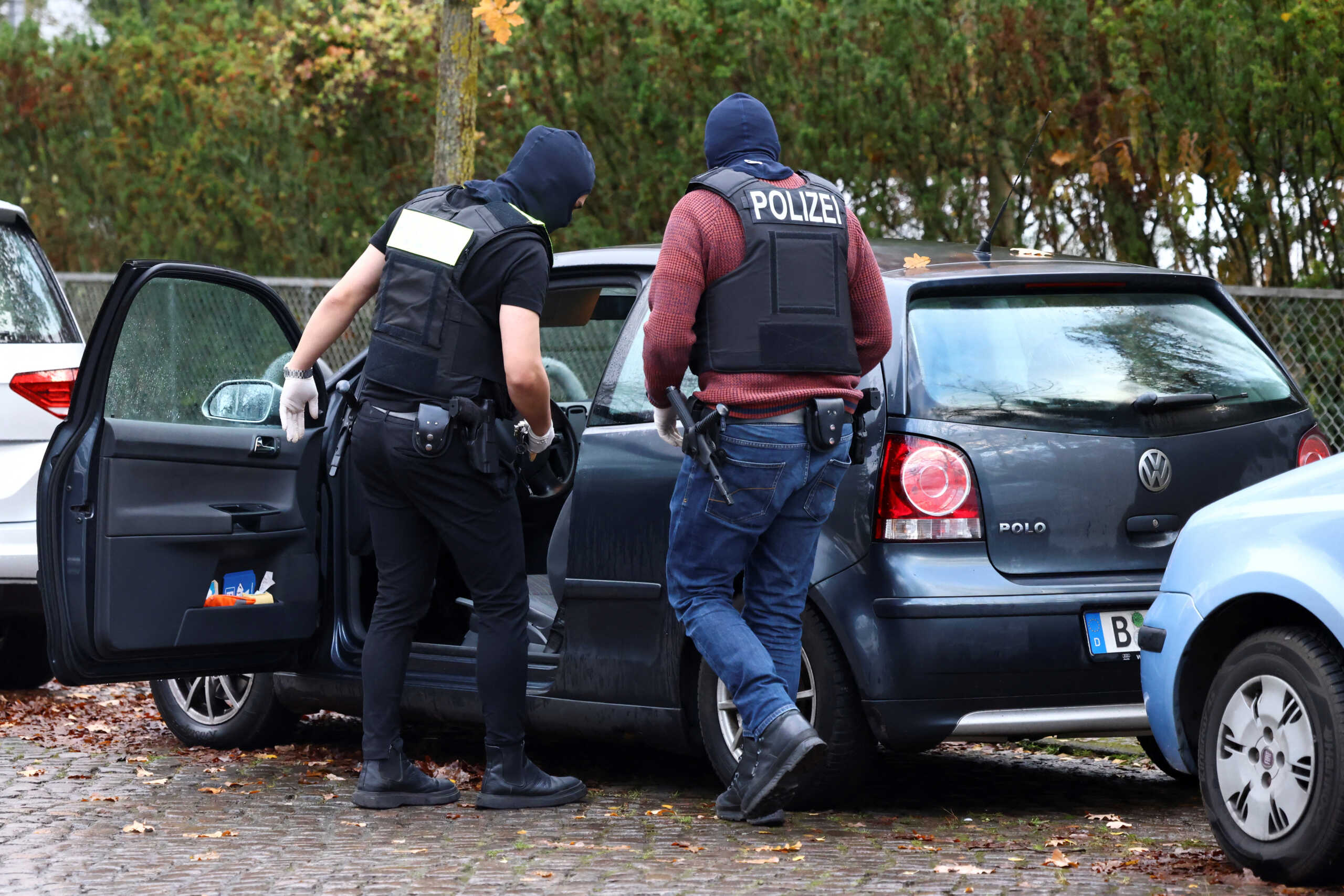 Police search a car as they secure the area after 25 suspected members and supporters of a far-right group were detained during raids across Germany, in Berlin, Germany December 7, 2022.   REUTERS