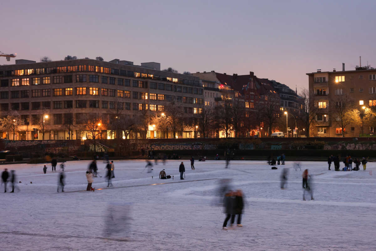 People skate on the frozen lake Engelbecken, in Berlin, Germany, December 18, 2022. REUTERS