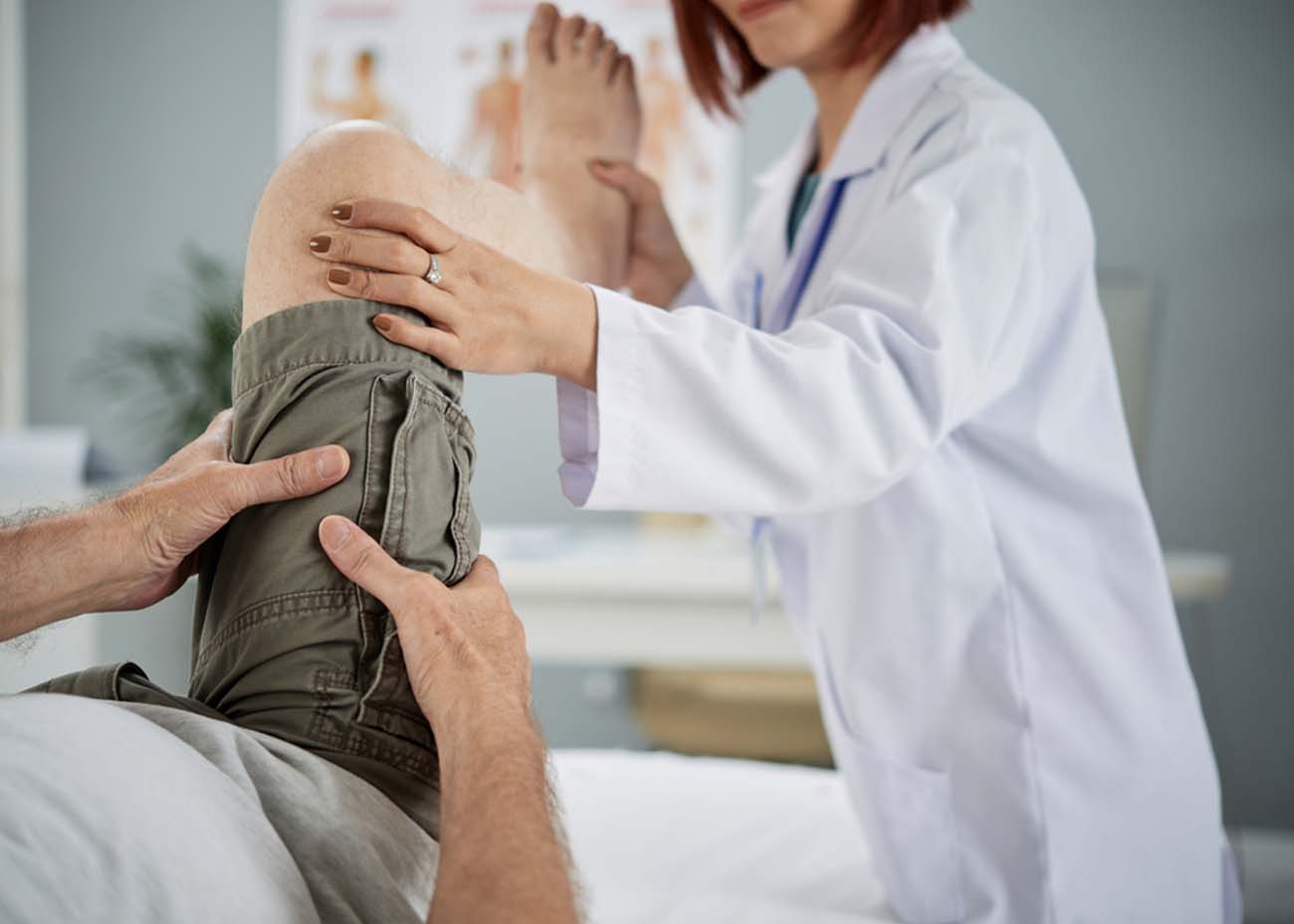 Elderly man attending physiotherapy in hospital