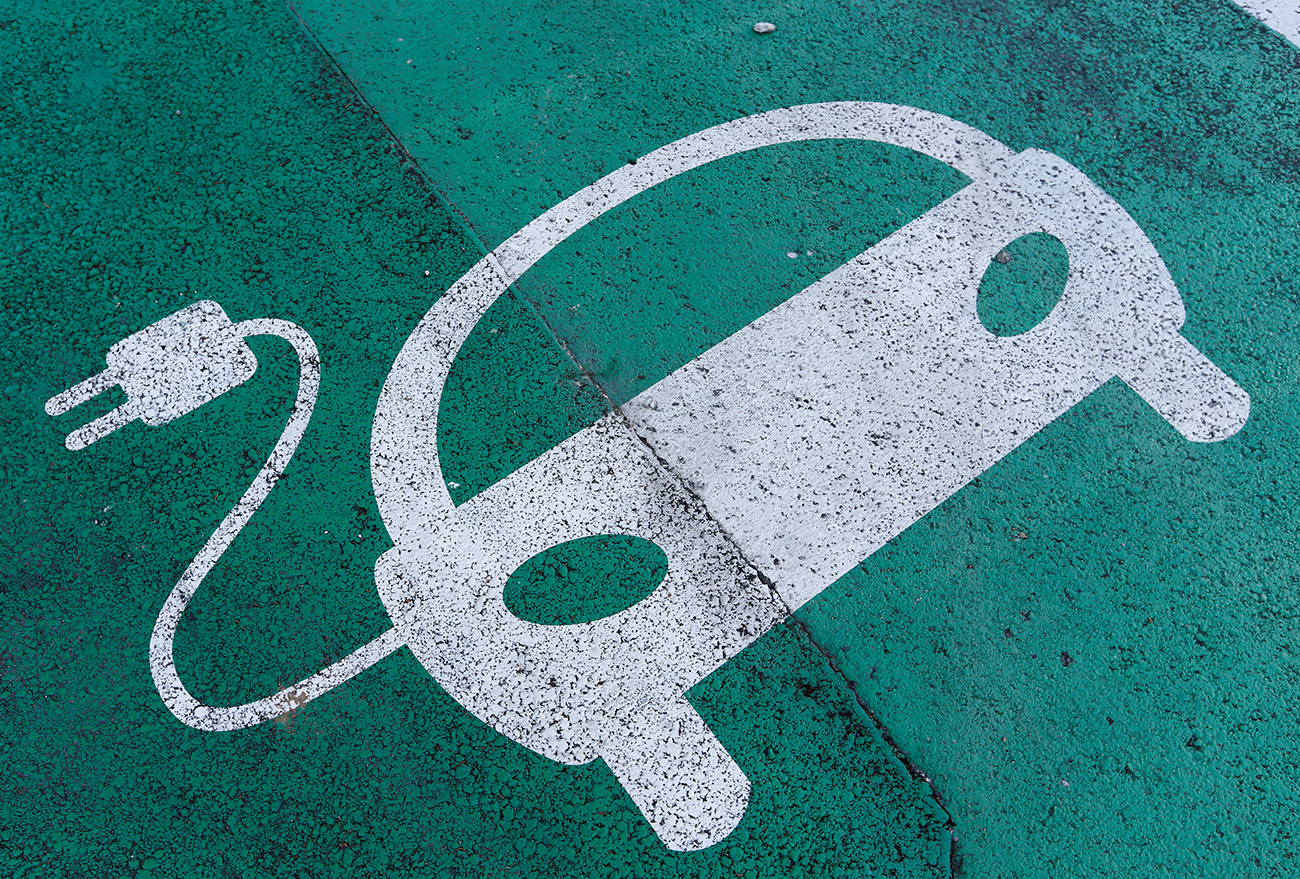 FILE PHOTO: A sign is pictured on an electric car charging station at the United Nations in Geneva, Switzerland June 2, 2017. REUTERS