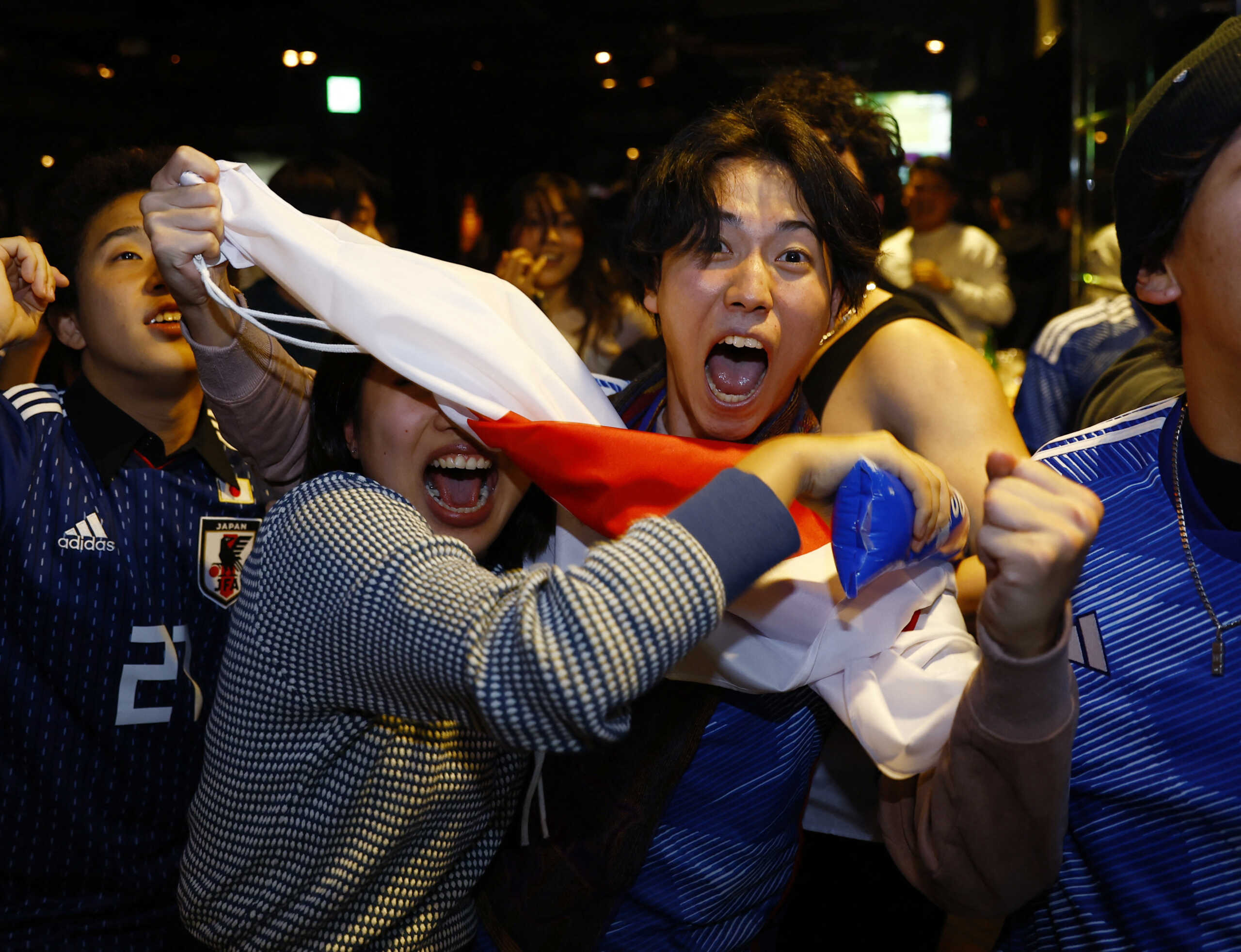 Soccer Football - FIFA World Cup Qatar 2022 - Fans in Tokyo watch Japan v Spain - Tokyo, Japan - December 2, 2022 Japan fans celebrate a goal at the Bee bar REUTERS