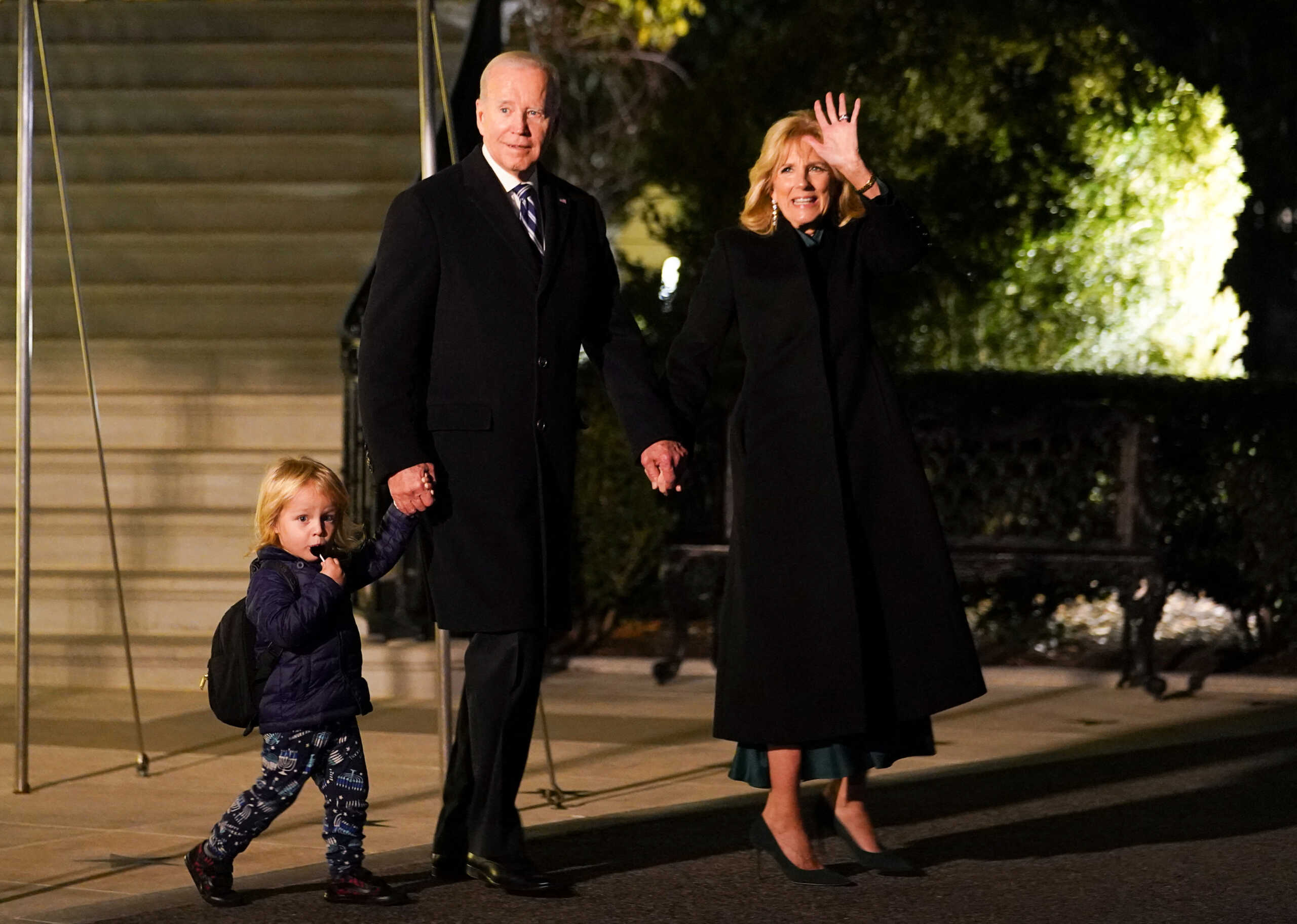 U.S. President Joe Biden holds hand of his grandson Beau as he and first lady Jill Biden depart for Wilmington from the White House in Washington, U.S., December 16, 2022. REUTERS