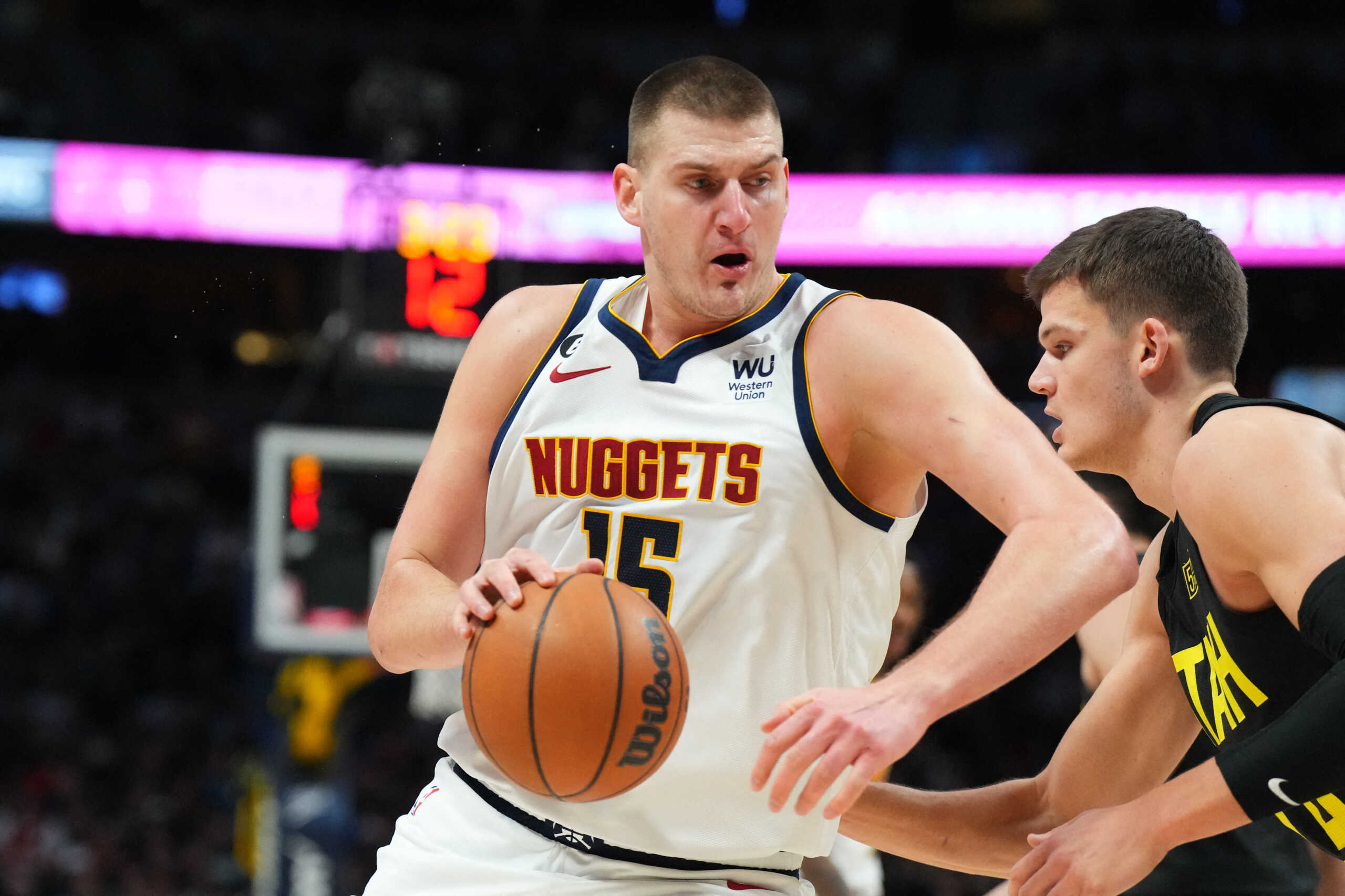 Dec 10, 2022; Denver, Colorado, USA; Denver Nuggets center Nikola Jokic (15) drives against Utah Jazz center Walker Kessler (24) in the second half at Ball Arena. Mandatory Credit: Ron Chenoy-USA TODAY Sports