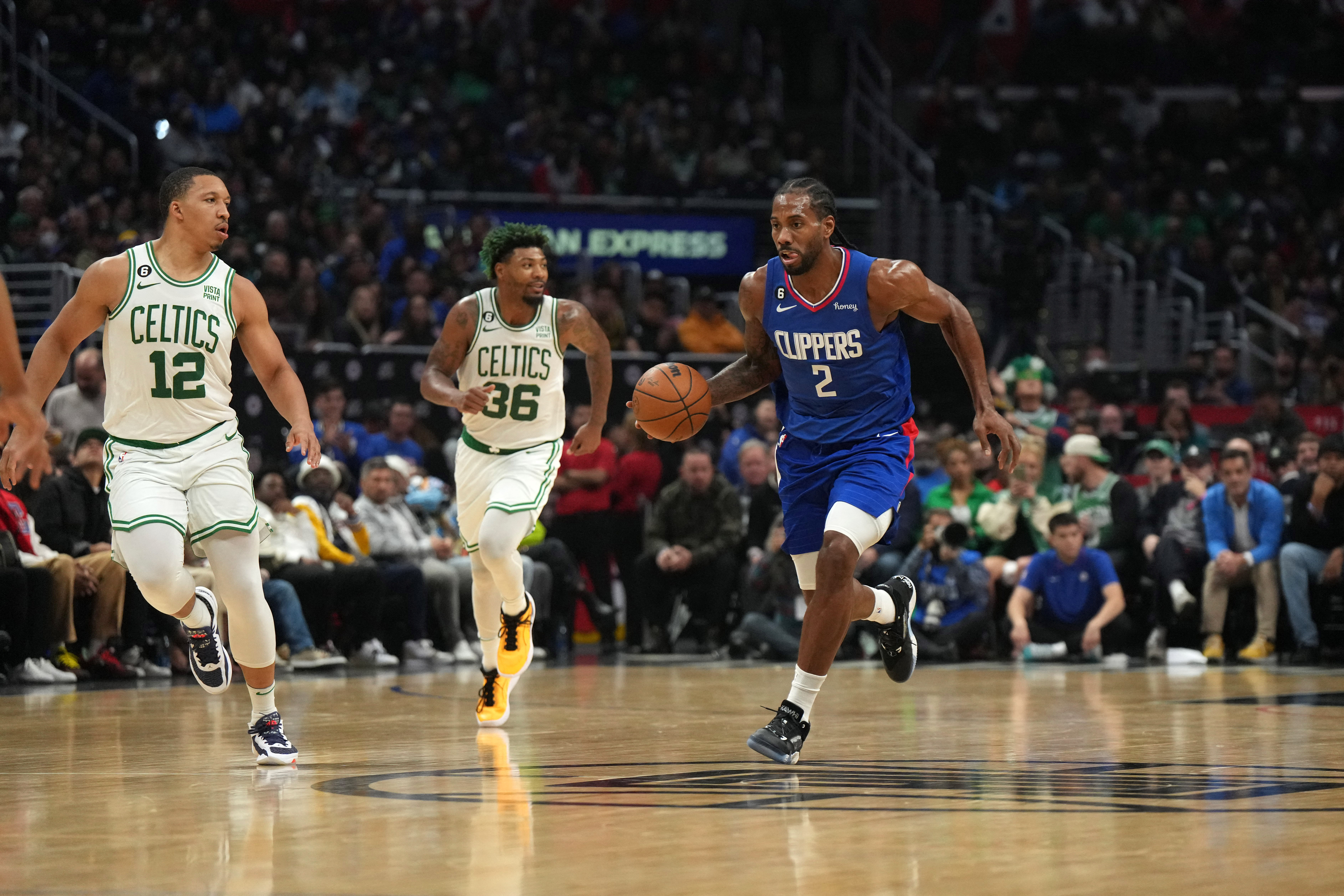 Dec 12, 2022; Los Angeles, California, USA; LA Clippers forward Kawhi Leonard (2) dribbles the ball against Boston Celtics forward Grant Williams (12) and guard Marcus Smart (36) in the second half at Crypto.com Arena. The Clippers defeated the Celtics 113-93. Mandatory Credit: Kirby Lee-USA TODAY Sports