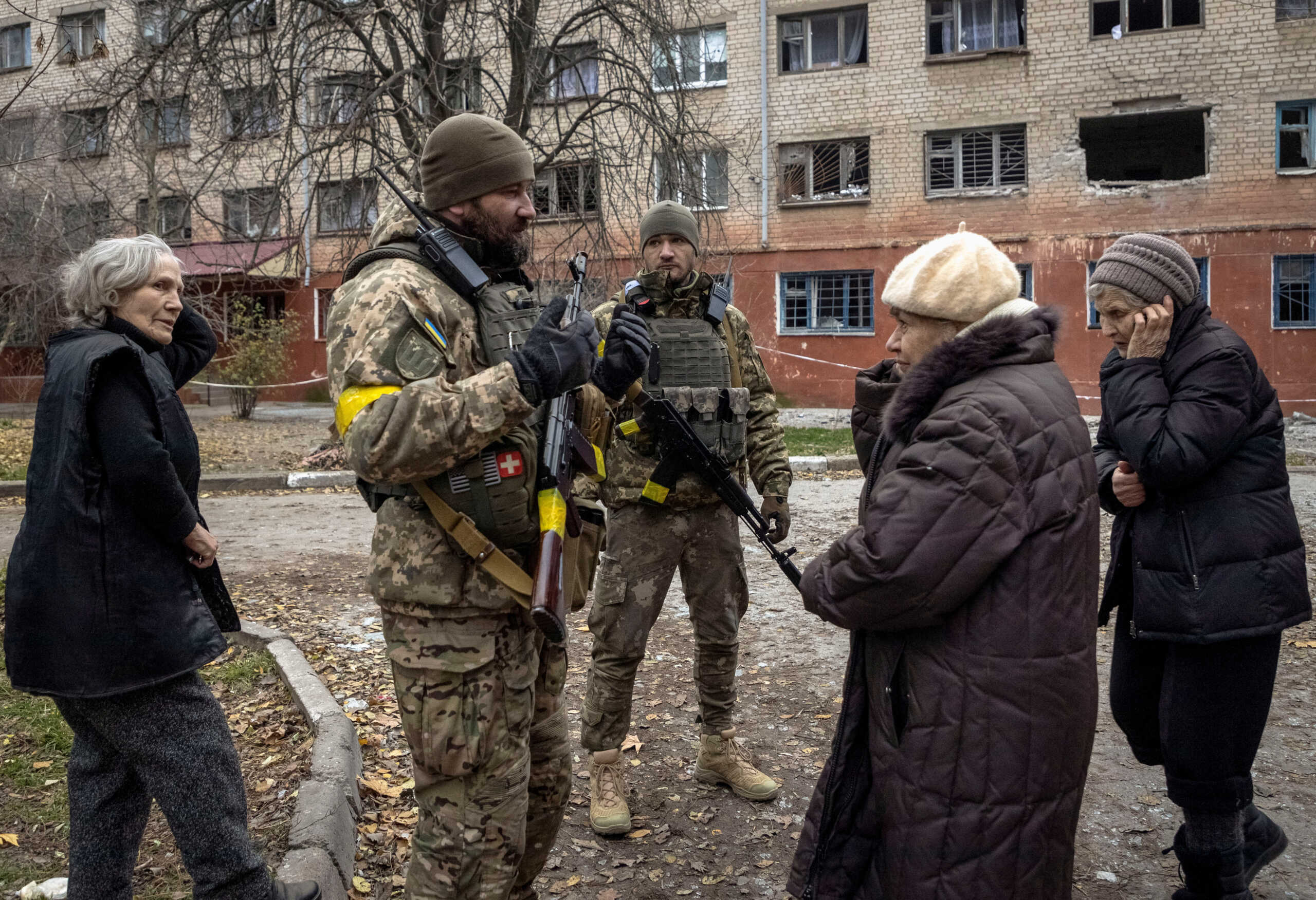 Ukrainian servicemen speak to local residents after Russia's military retreat from Kherson, Ukraine December 1, 2022. REUTERS