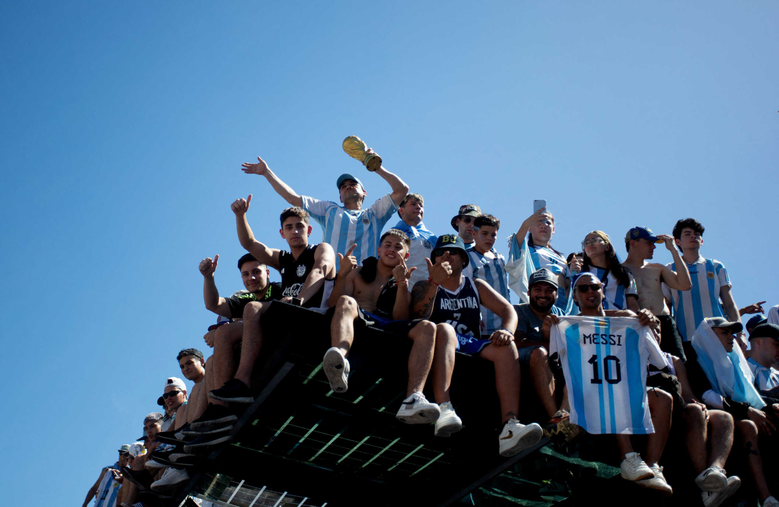 Soccer Football - FIFA World Cup Qatar 2022 - Argentina Victory Parade after winning the World Cup - Buenos Aires, Argentina - December 20, 2022  Argentina fans display a replica trophy and a Lionel Messi shirt ahead of the victory parade REUTERS