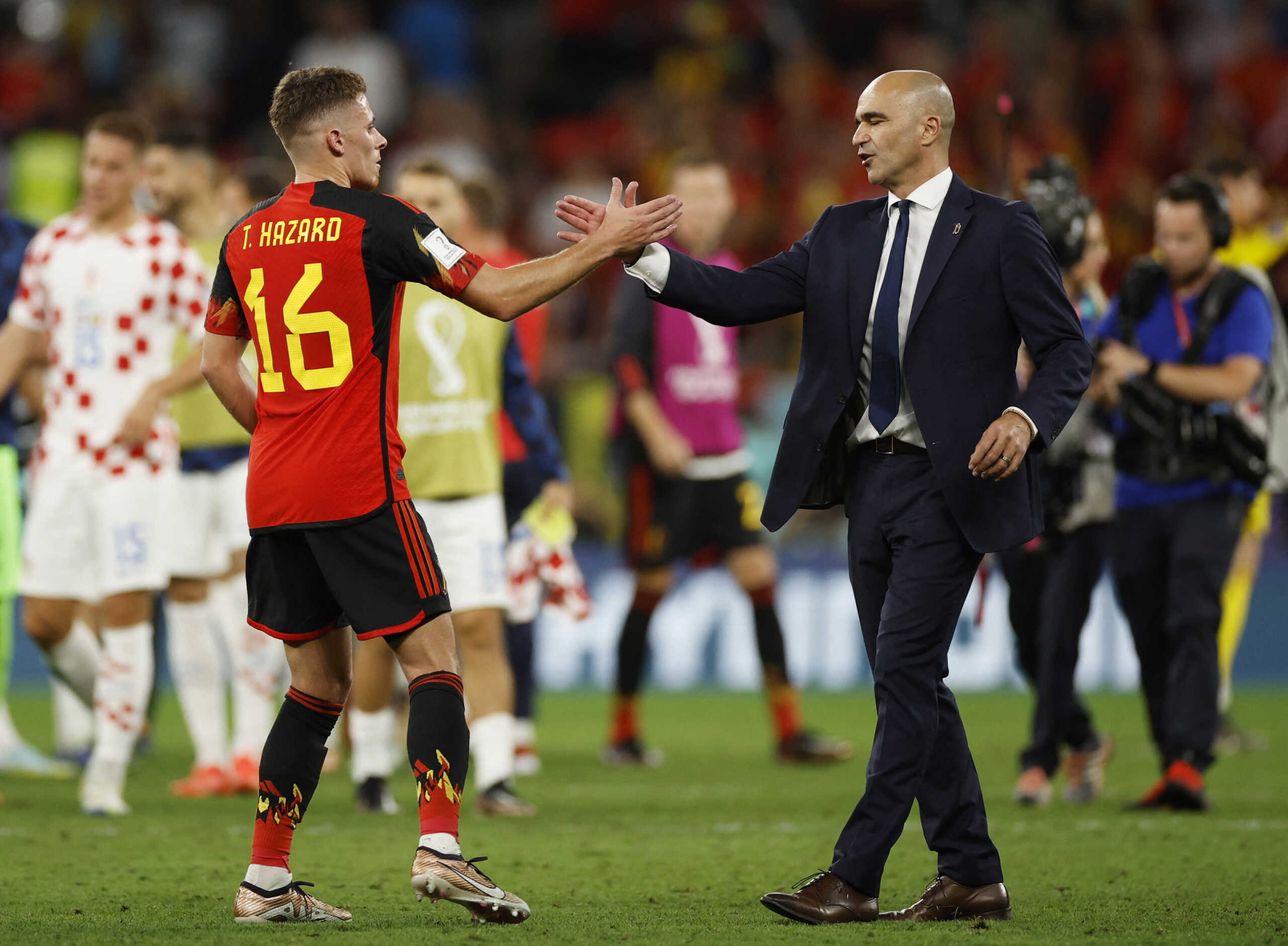 Soccer Football - FIFA World Cup Qatar 2022 - Group F - Croatia v Belgium - Ahmad Bin Ali Stadium, Al Rayyan, Qatar - December 1, 2022  Belgium coach Roberto Martinez shakes hands with Thorgan Hazard after the match as Belgium are eliminated from the World Cup REUTERS