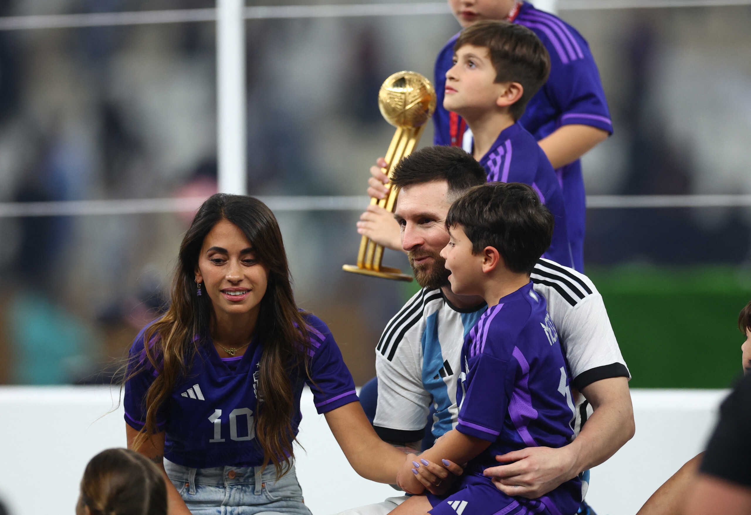 Soccer Football - FIFA World Cup Qatar 2022 - Final - Argentina v France - Lusail Stadium, Lusail, Qatar - December 18, 2022 Argentina's Lionel Messi sits with his wife Antonela Roccuzzo and sons Ciro, Mateo and Thiago after winning the World Cup REUTERS