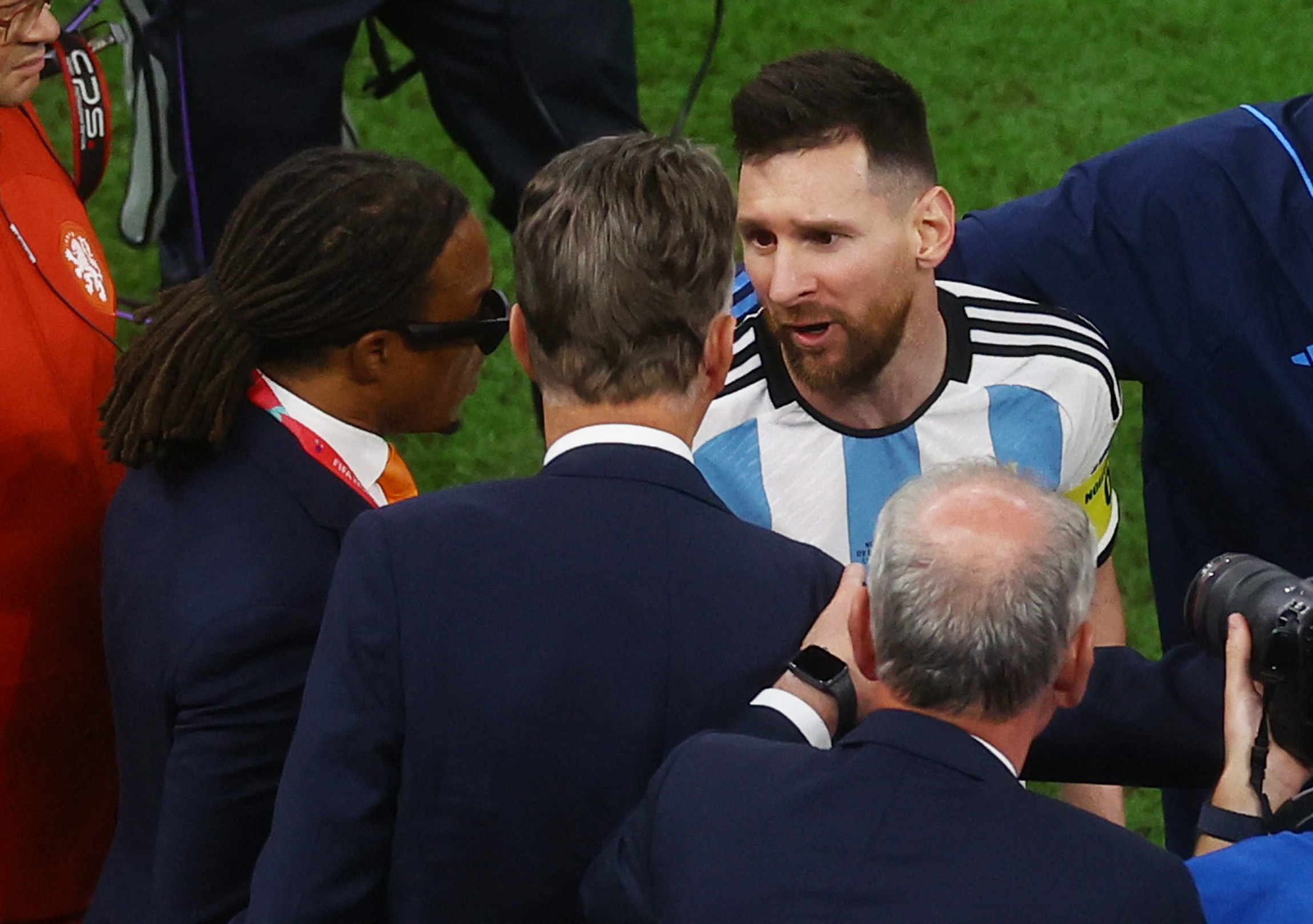Soccer Football - FIFA World Cup Qatar 2022 - Quarter Final - Netherlands v Argentina - Lusail Stadium, Lusail, Qatar - December 10, 2022  Argentina's Lionel Messi with Netherlands coach Louis van Gaal and assistant coach Edgar Davids after the penalty shootout as Argentina progress to the semi finals and Netherlands are eliminated from the World Cup REUTERS