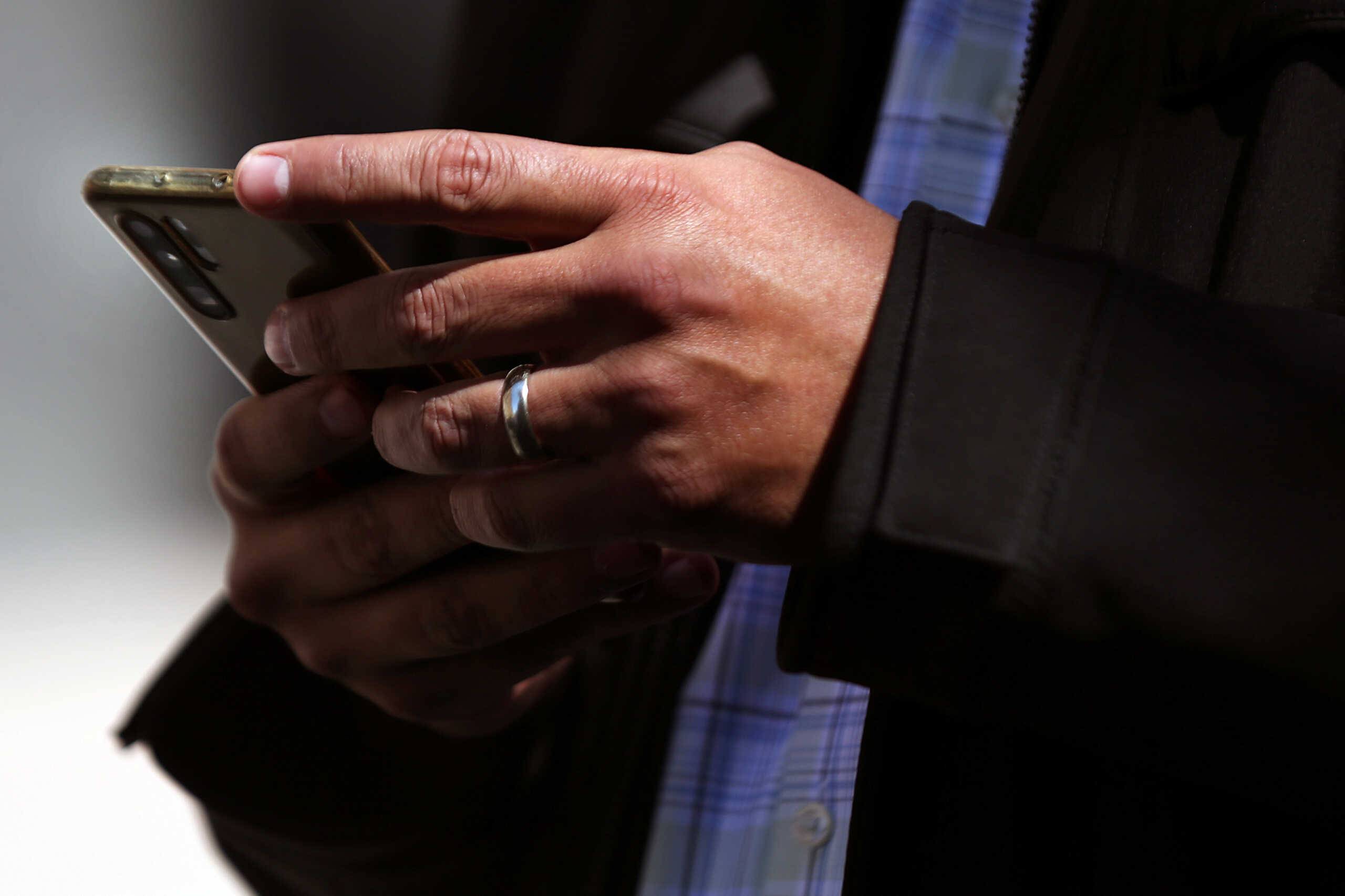 A man holds his mobile phone in downtown Mexico City, Mexico, February 3, 2021. Picture taken February 3, 2021. REUTERS