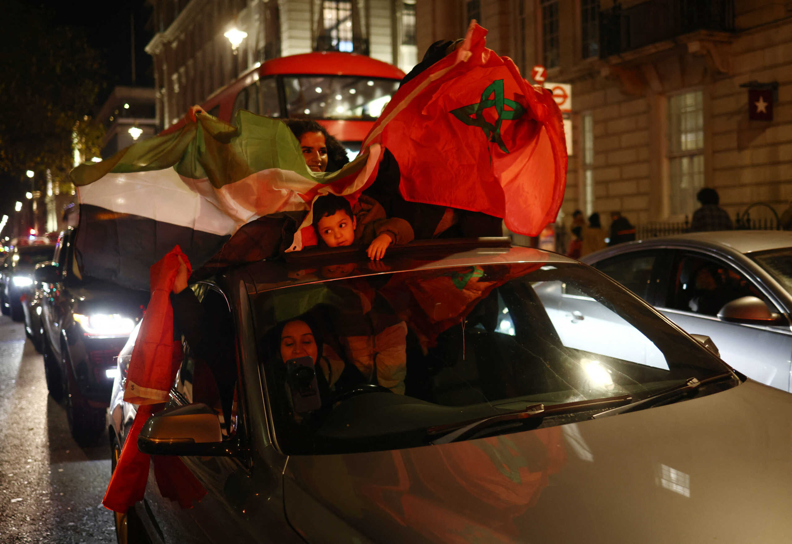 Soccer Football - FIFA World Cup Qatar 2022 - Morocco fans in London after the Morocco v Portugal match - London, Britain - December 10, 2022   Morocco fans with flags celebrate after reaching the semi final REUTERS