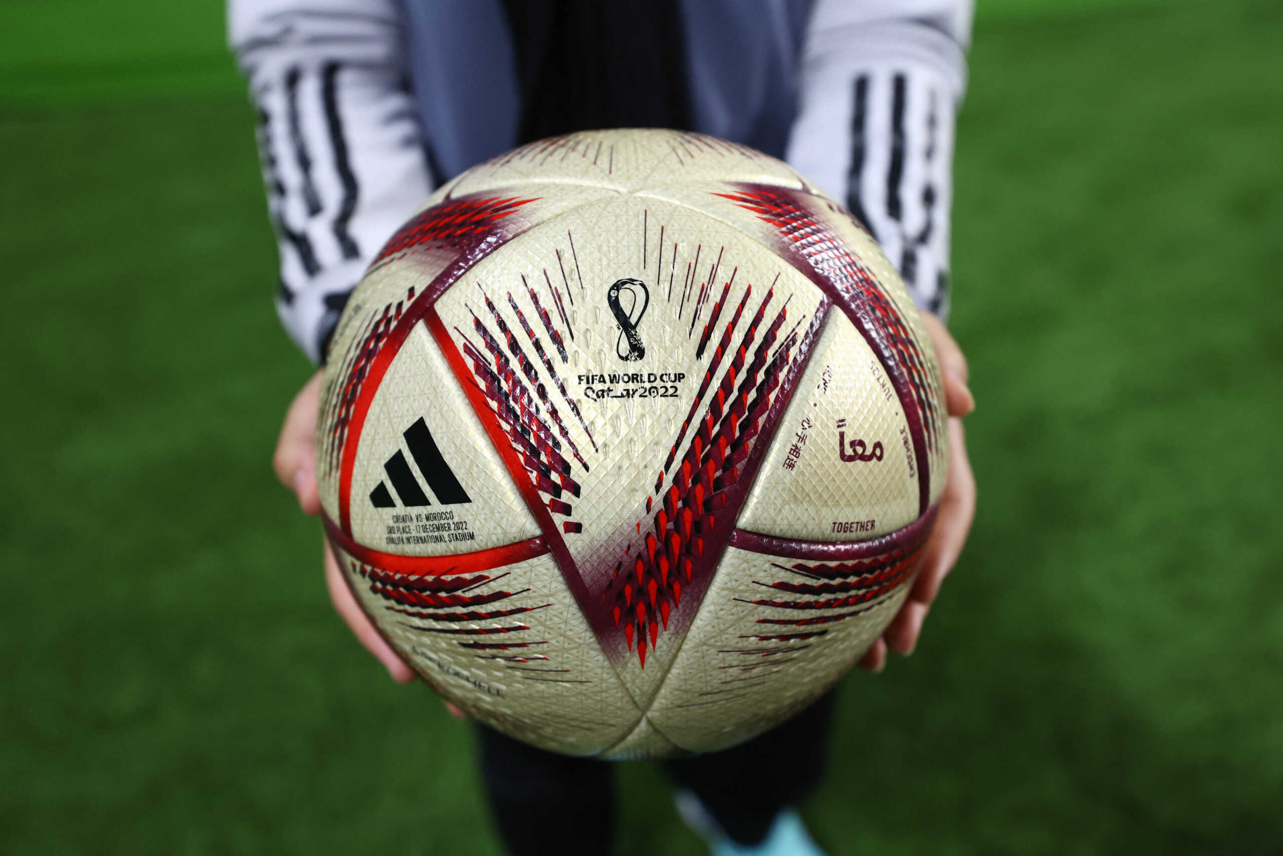 Soccer Football - FIFA World Cup Qatar 2022 - Third-Place Playoff - Croatia v Morocco - Khalifa International Stadium, Doha, Qatar - December 17, 2022 A volunteer is seen holding the FIFA World Cup Qatar 2022 match ball REUTERS