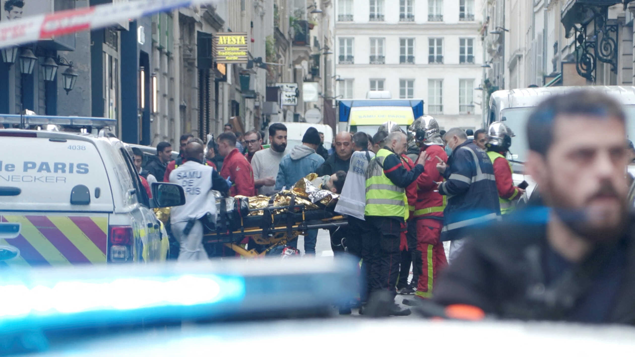 First responders move a man on a gurney after gunshots were fired in central Paris, France, December 23, 2022, in this still image obtained form a social media video. Clement Lanot
